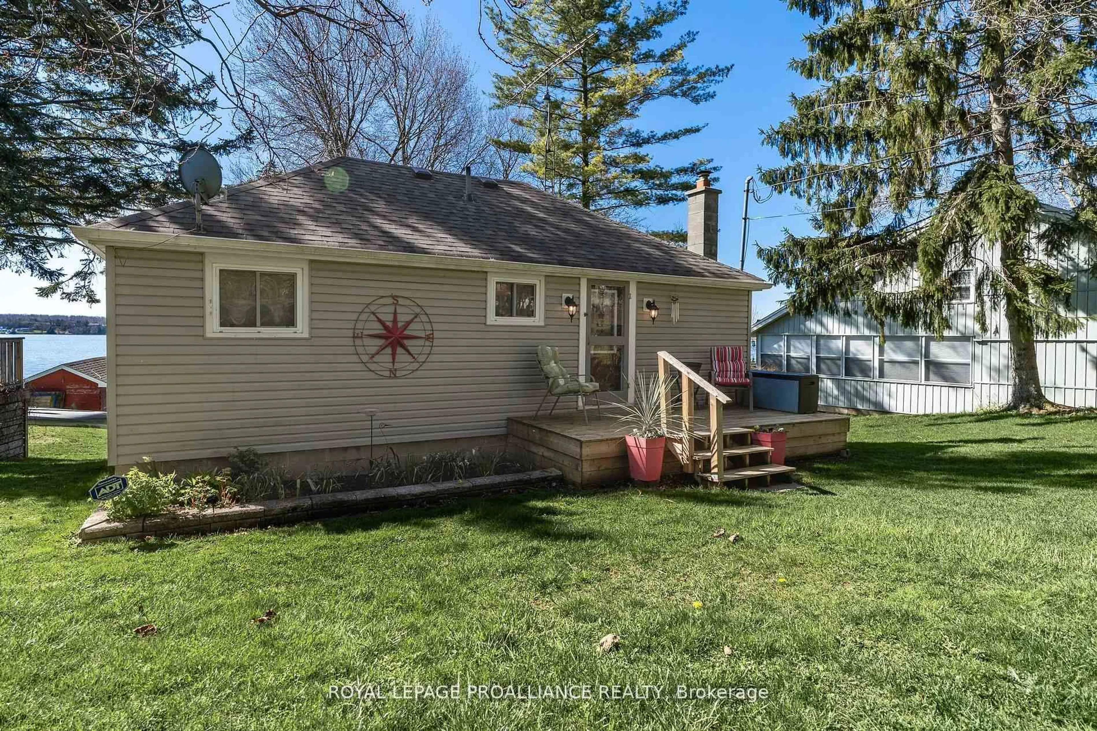 Home with vinyl exterior material, street for 1051 Lakeside Dr, Prince Edward County Ontario K0K 1T0