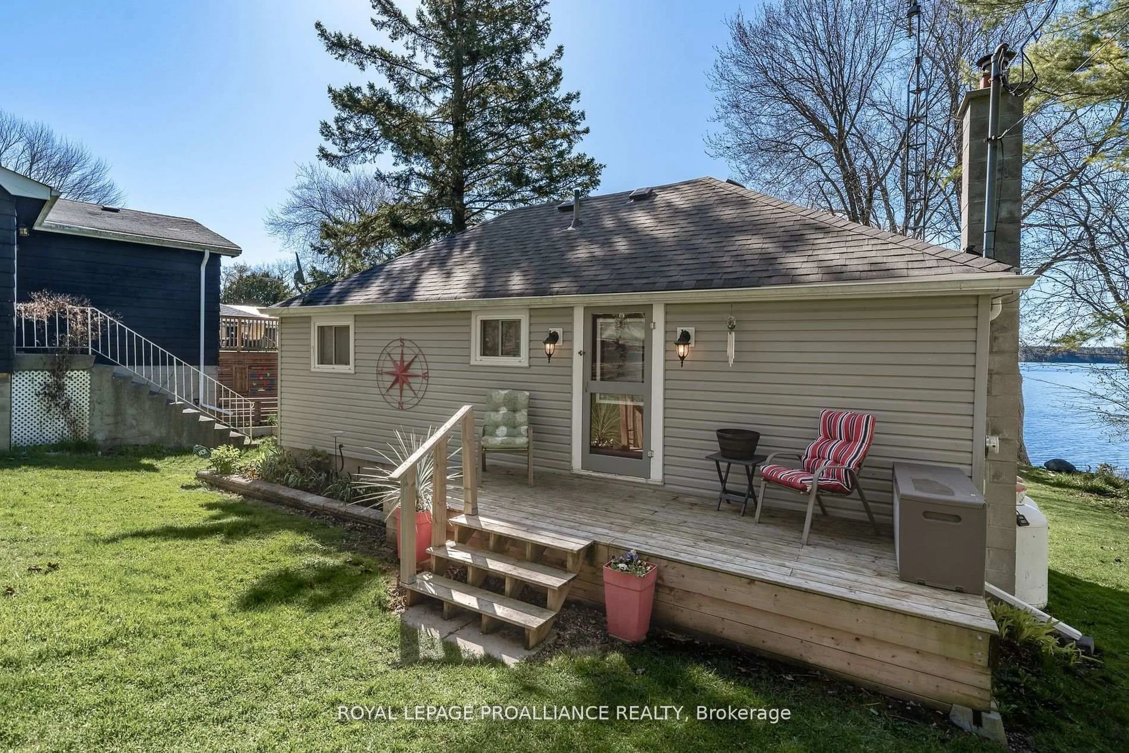 Home with vinyl exterior material, street for 1051 Lakeside Dr, Prince Edward County Ontario K0K 1T0