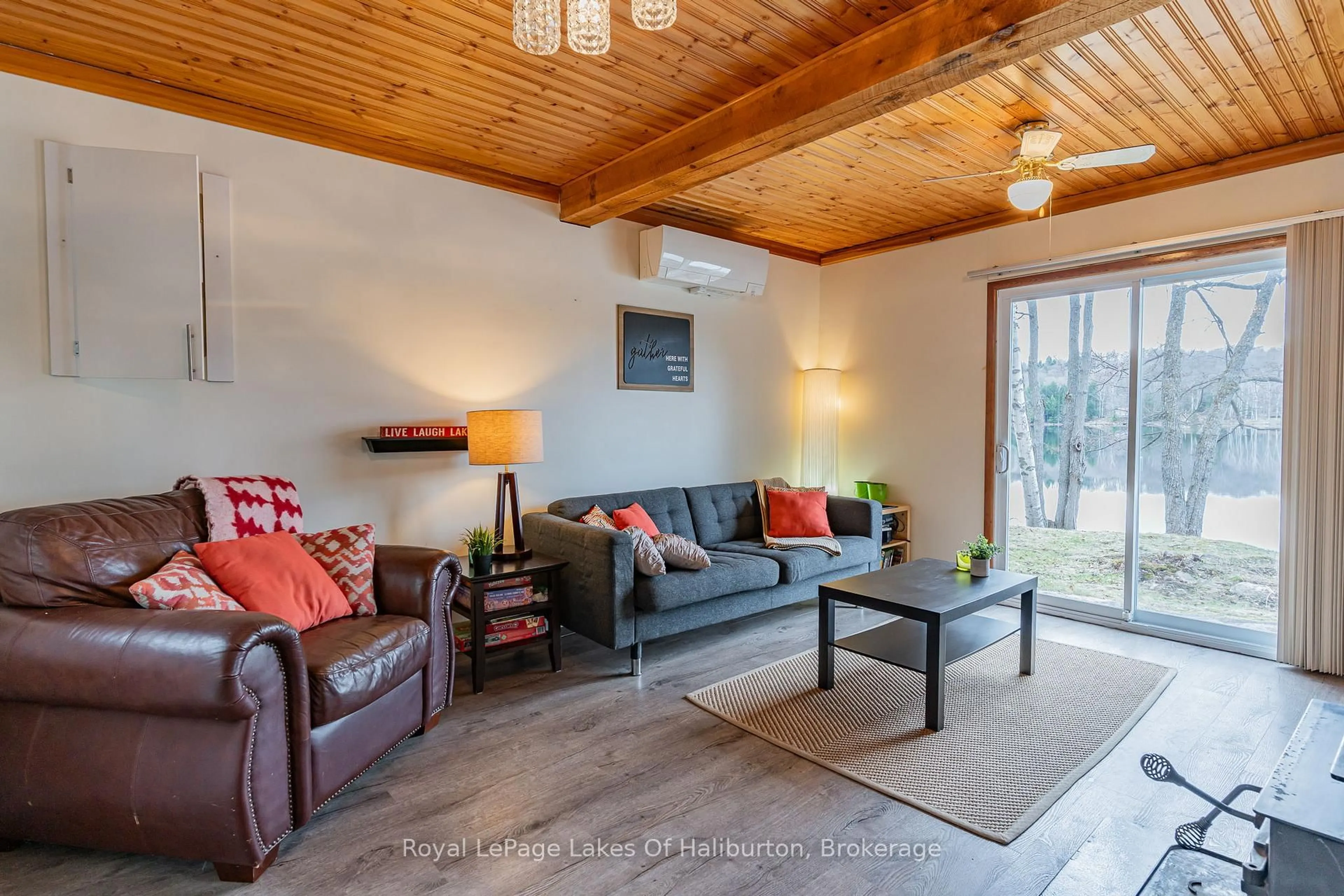 Living room with furniture, wood/laminate floor for 1216 Lake Lorraine Rd, Highlands East Ontario K0L 2Y0