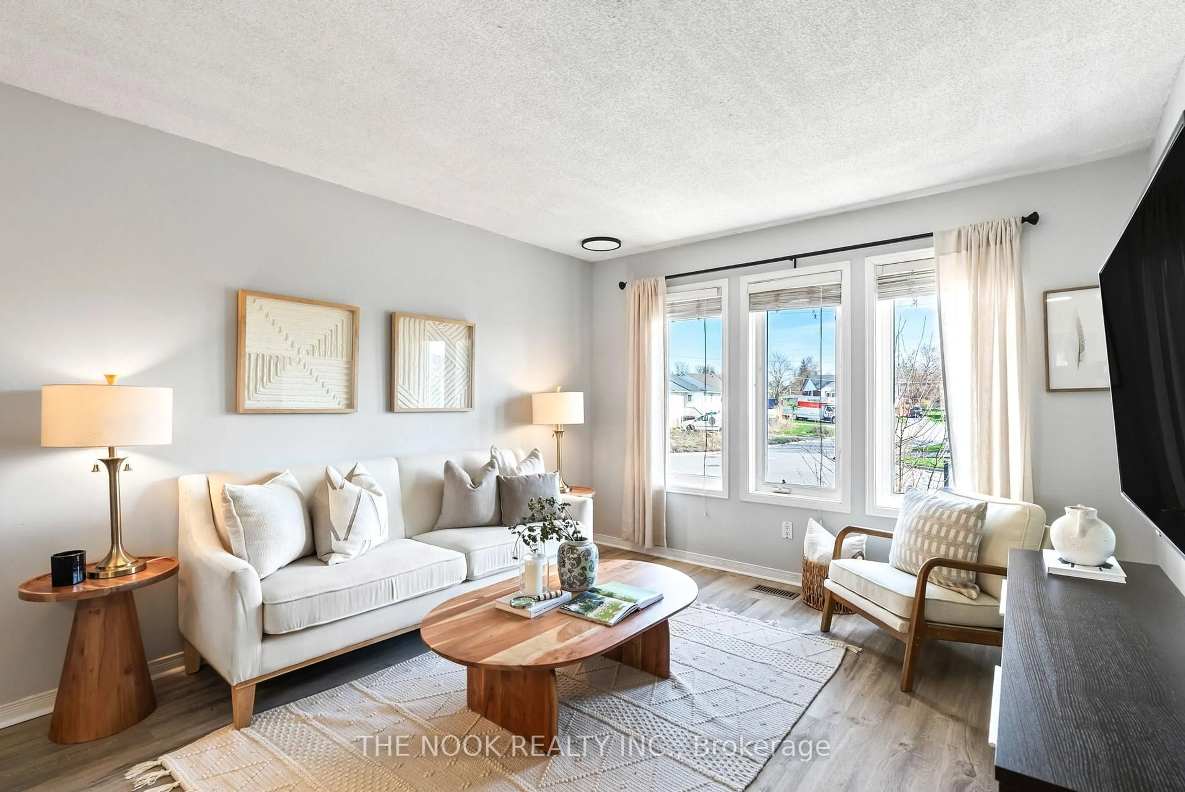 Living room with furniture, wood/laminate floor for 16 Cottingham Cres, Kawartha Lakes Ontario K9V 1T9
