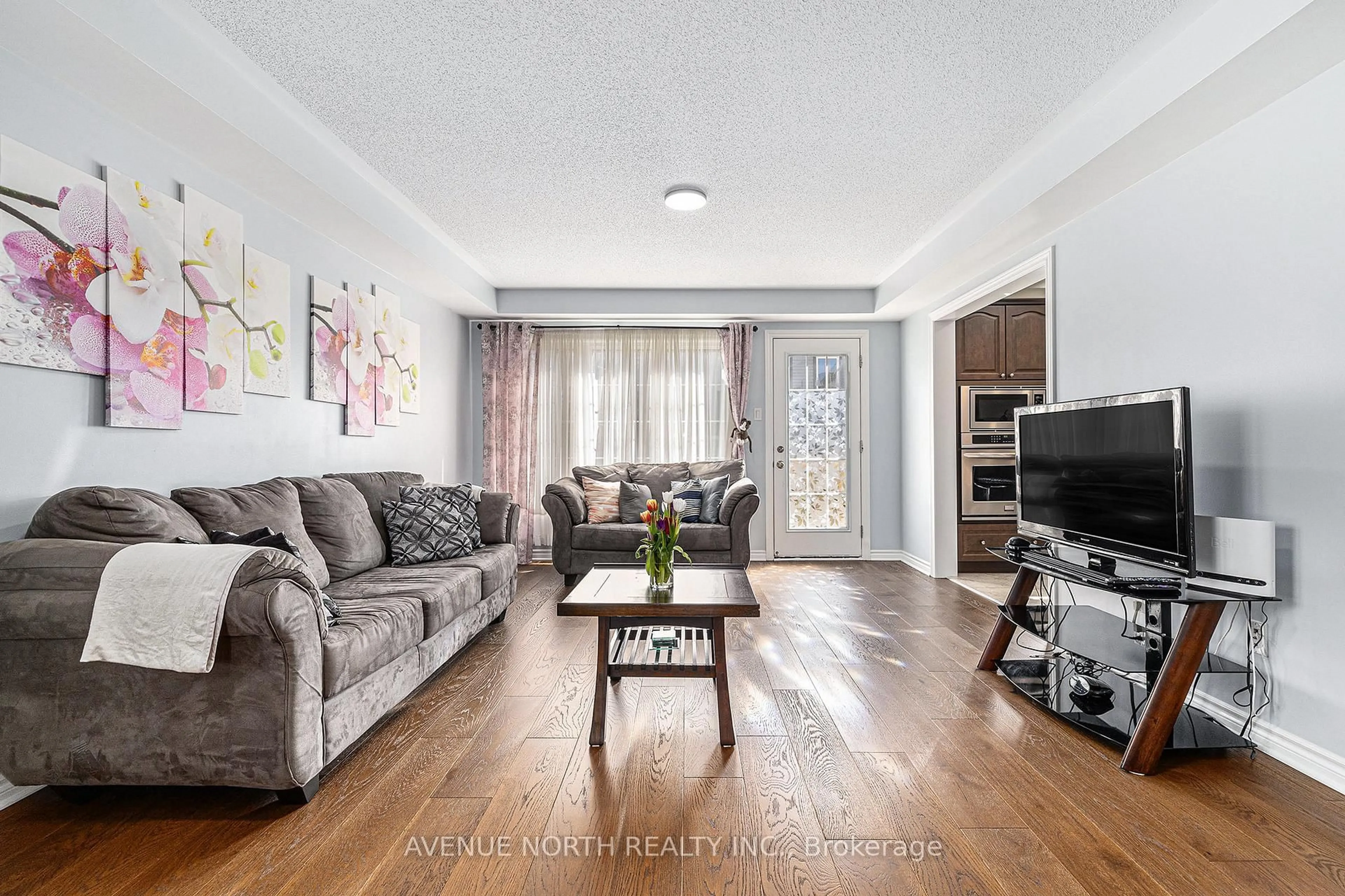 Living room with furniture, wood/laminate floor for 30 Solaris Dr, Ottawa Ontario K2M 0L6