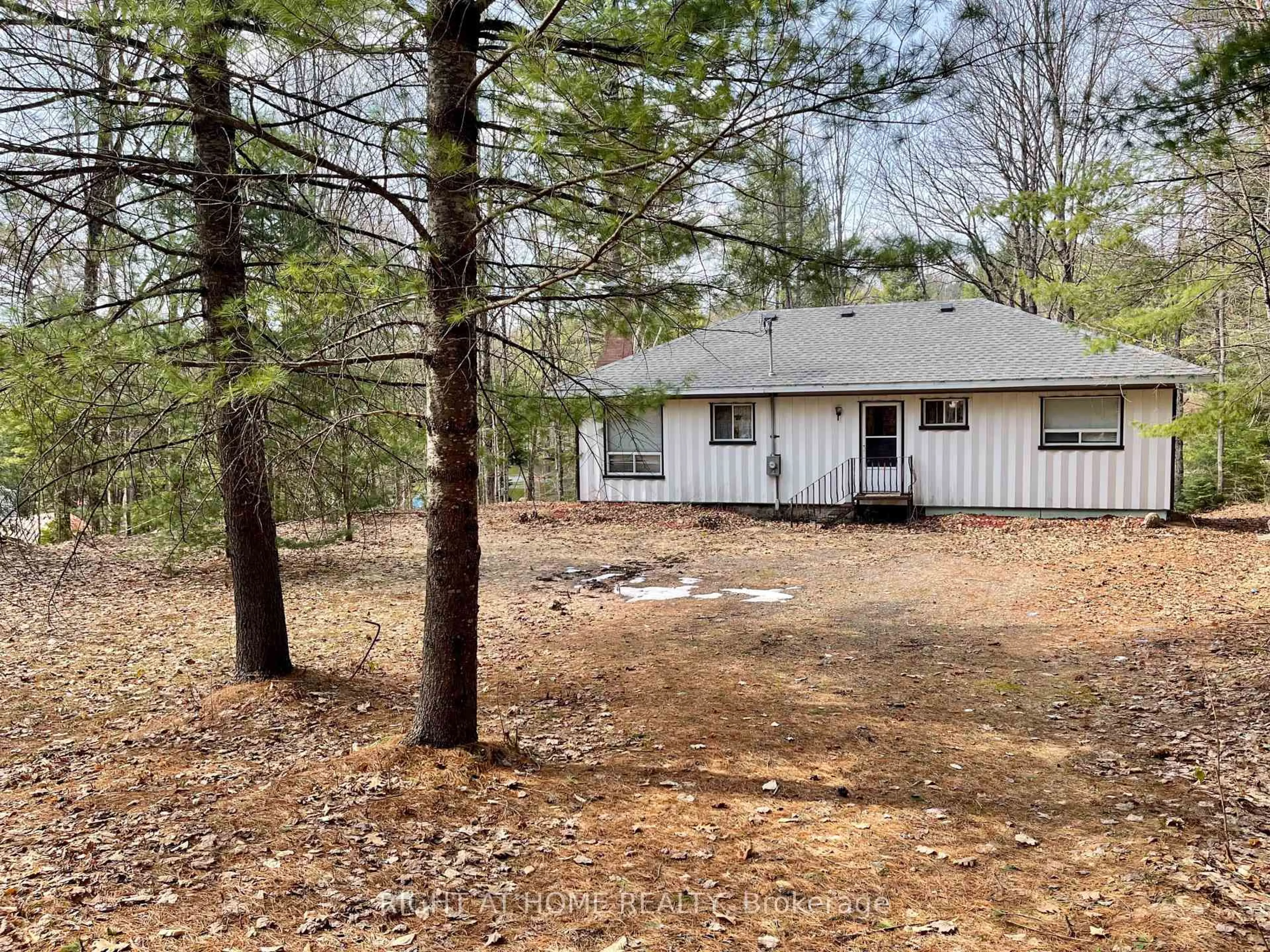 A pic from outside/outdoor area/front of a property/back of a property/a pic from drone, forest/trees view for 1114 River Haven Rd, Bracebridge Ontario P1L 1X1