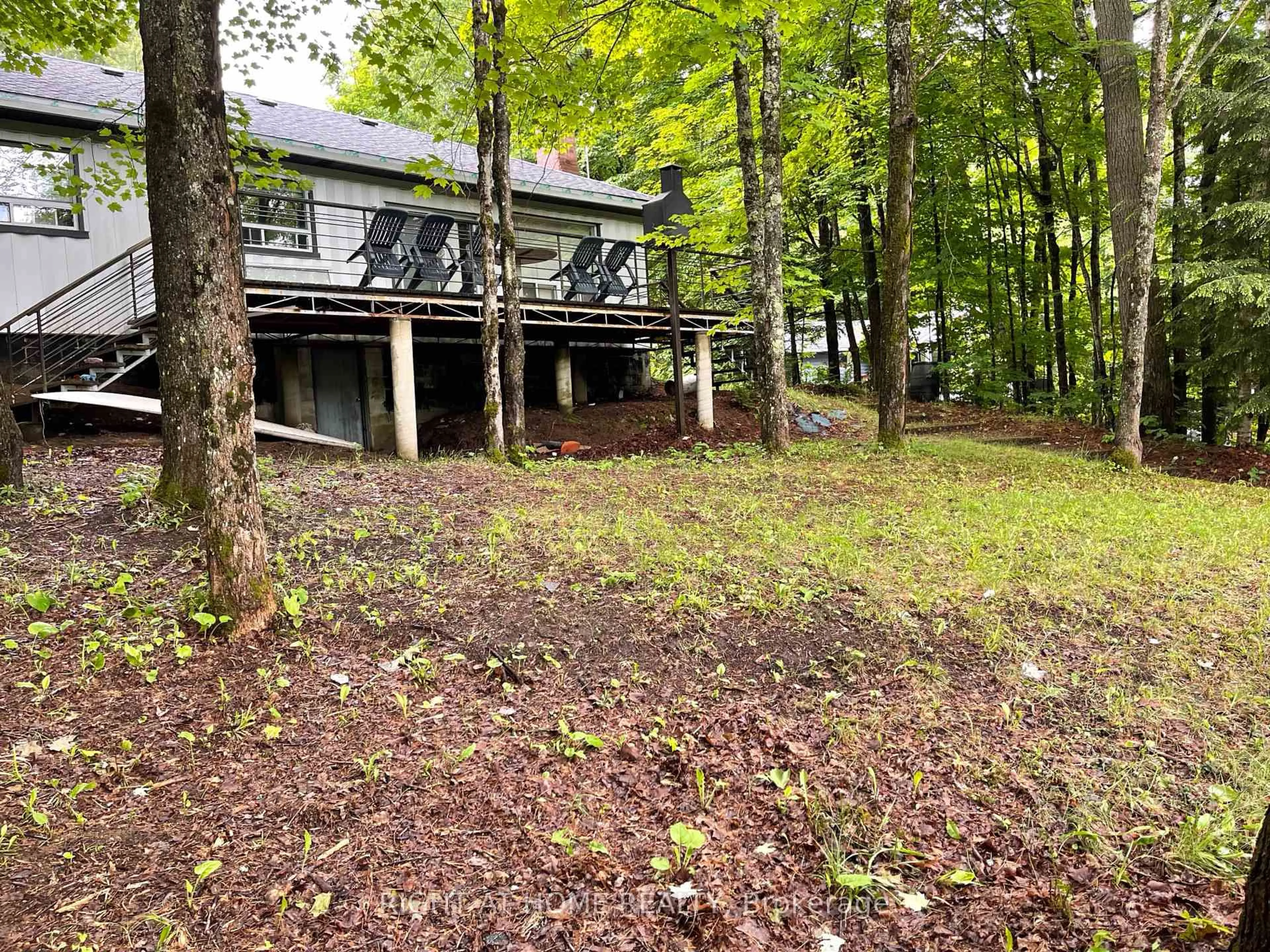 A pic from outside/outdoor area/front of a property/back of a property/a pic from drone, forest/trees view for 1114 River Haven Rd, Bracebridge Ontario P1L 1X1