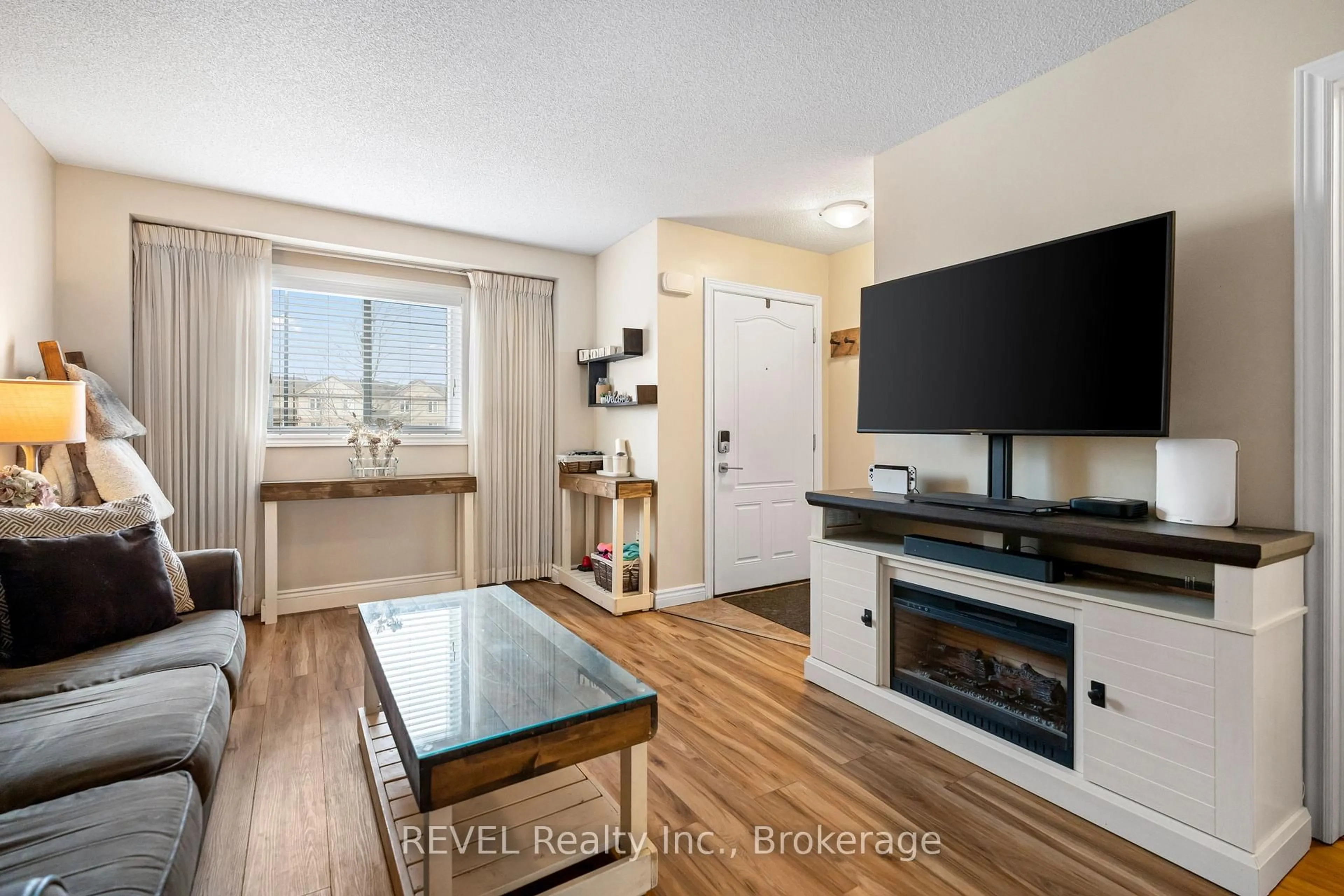 Living room with furniture, wood/laminate floor for 6118 Kelsey Cres #11, Niagara Falls Ontario L2H 0M6
