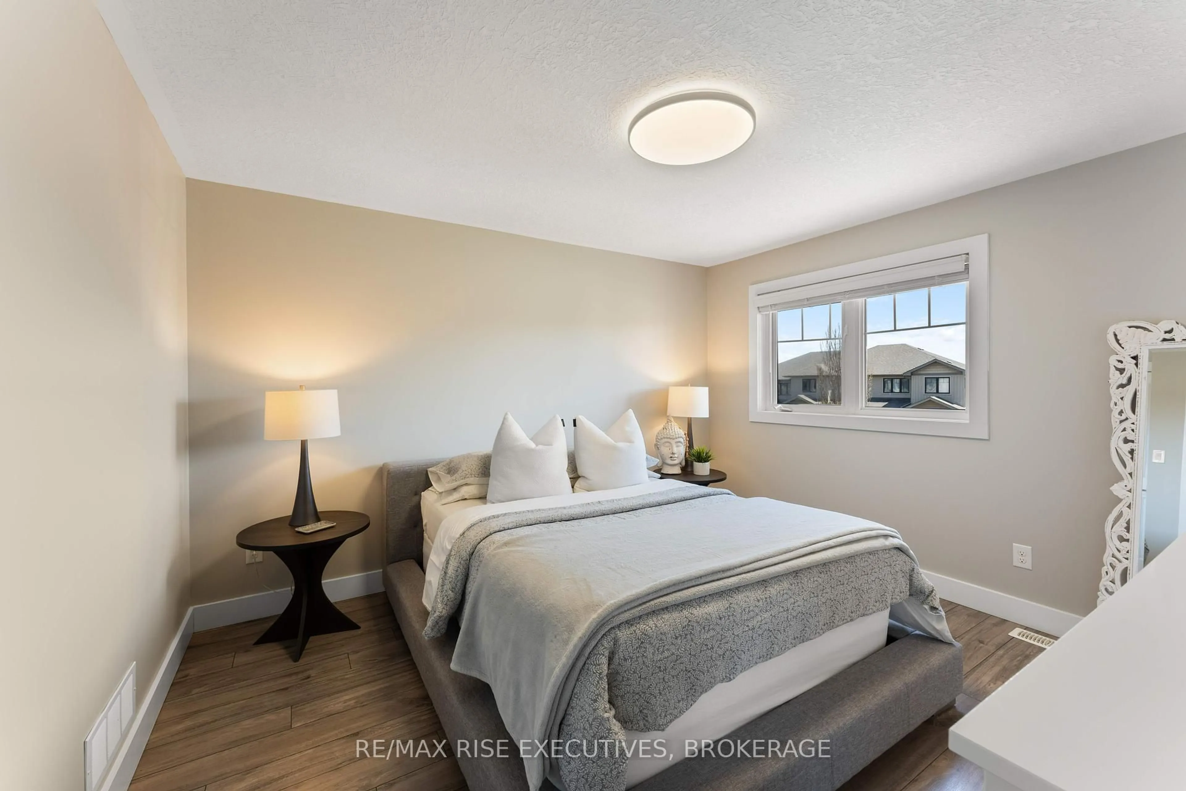 Bedroom with bed, wood/laminate floor for 125 Simurda Crt, Loyalist Ontario K7N 1Y7