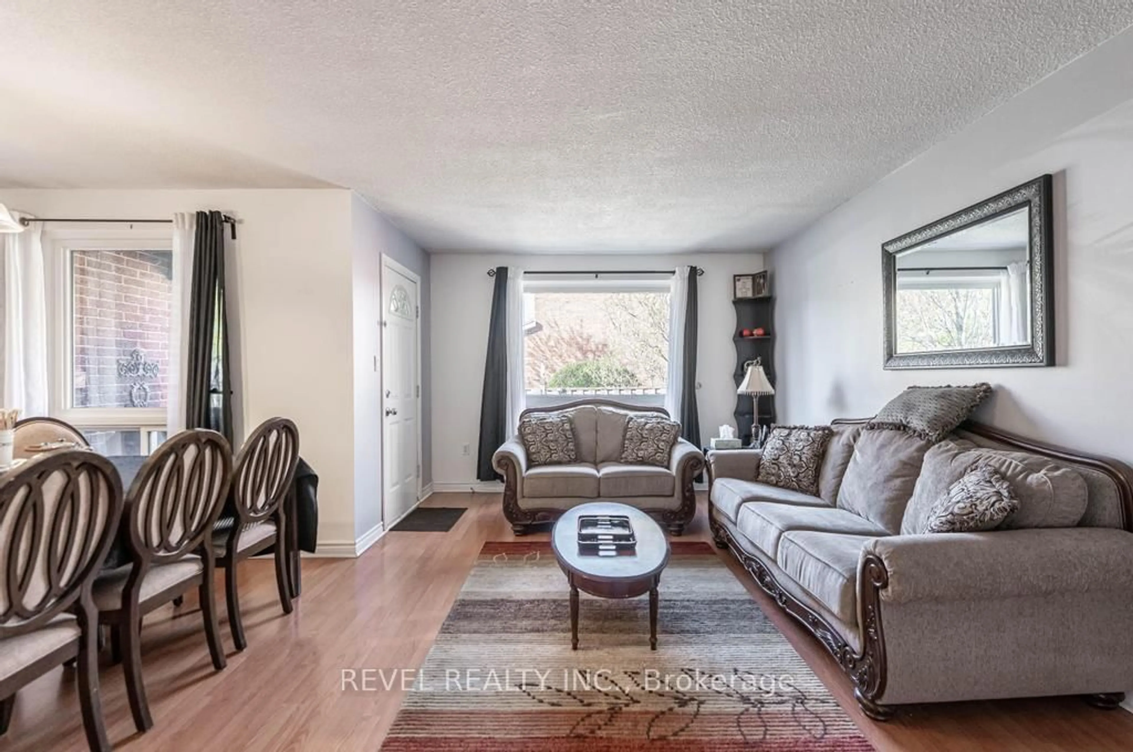 Living room with furniture, wood/laminate floor for 25 Redbury St #28, Hamilton Ontario L8W 1P7