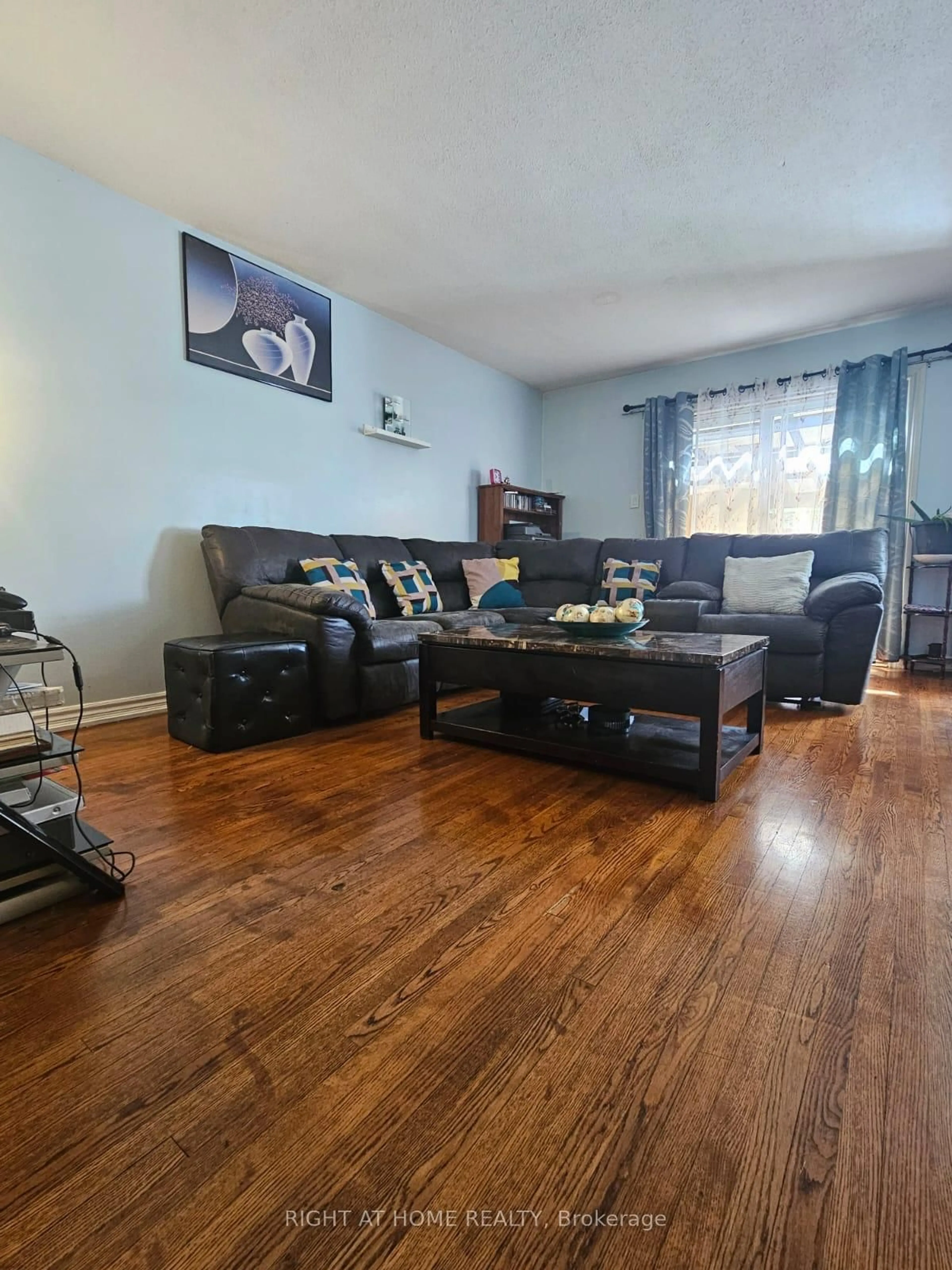 Living room with furniture, wood/laminate floor for 2415 Southvale Cres, Ottawa Ontario K1B 4J5