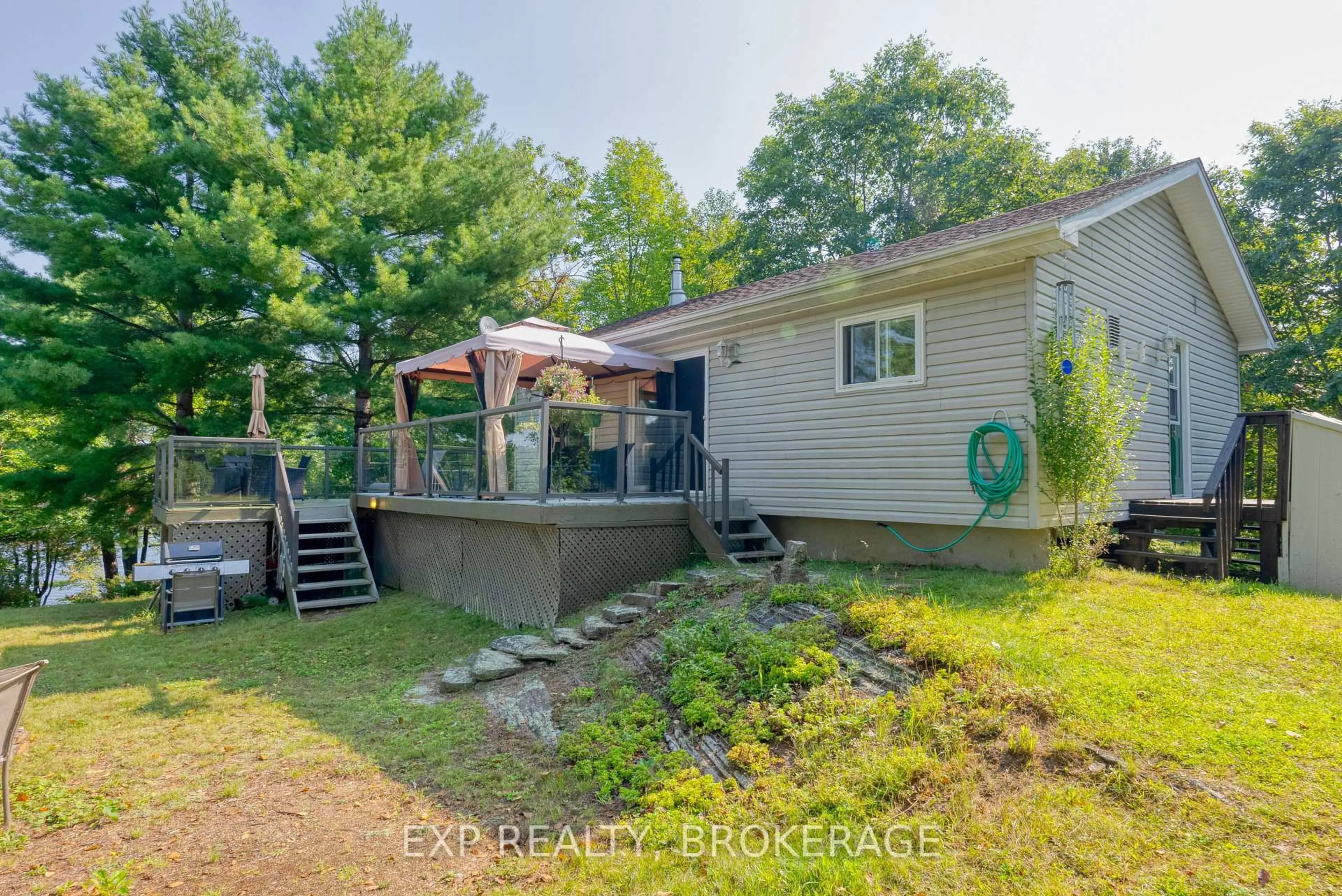 A pic from outside/outdoor area/front of a property/back of a property/a pic from drone, water/lake/river/ocean view for 1040 WATERS EDGE Lane, Arden Ontario K0H 1B0