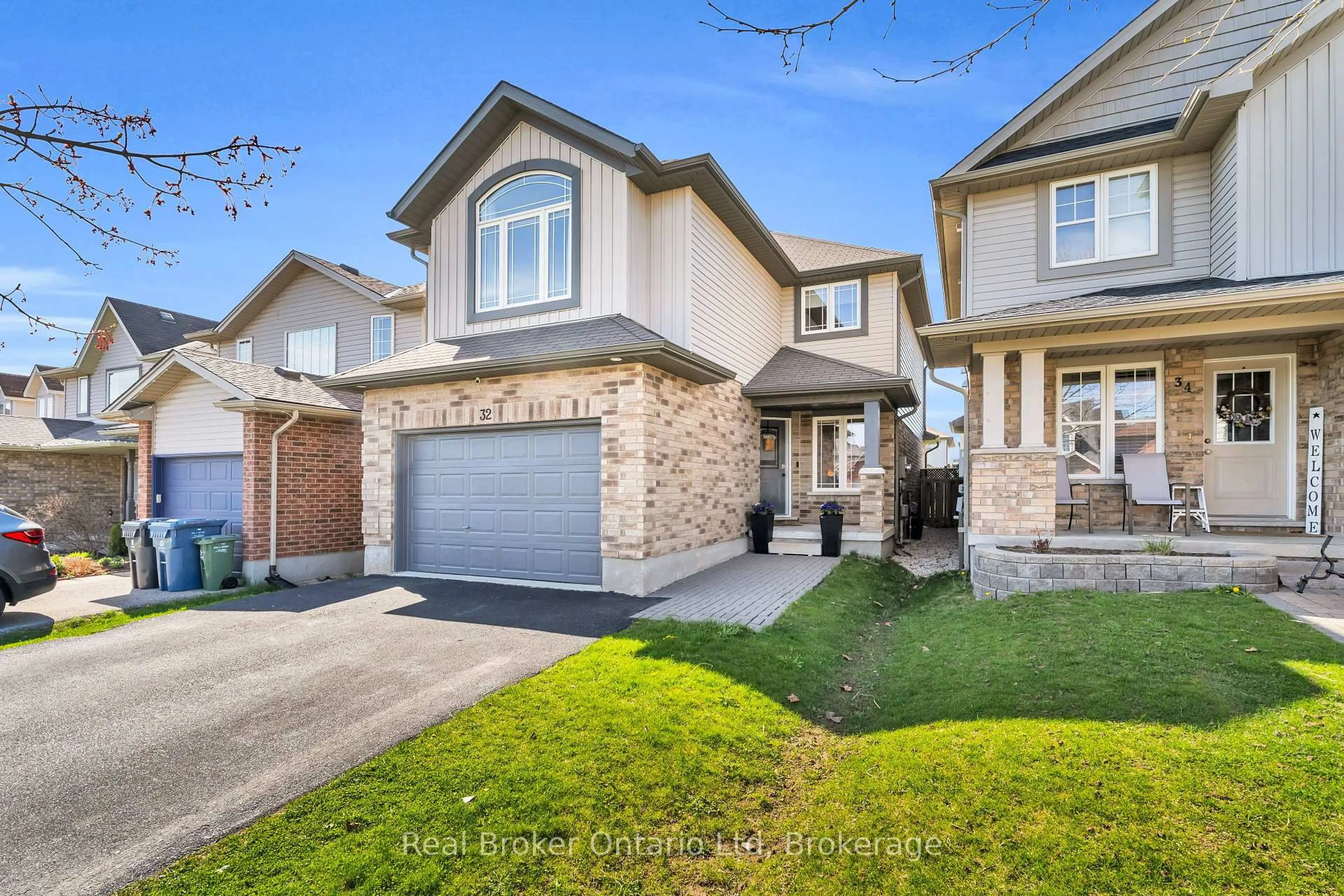 Home with brick exterior material, street for 32 Maude Lane, Guelph Ontario N1E 0G3