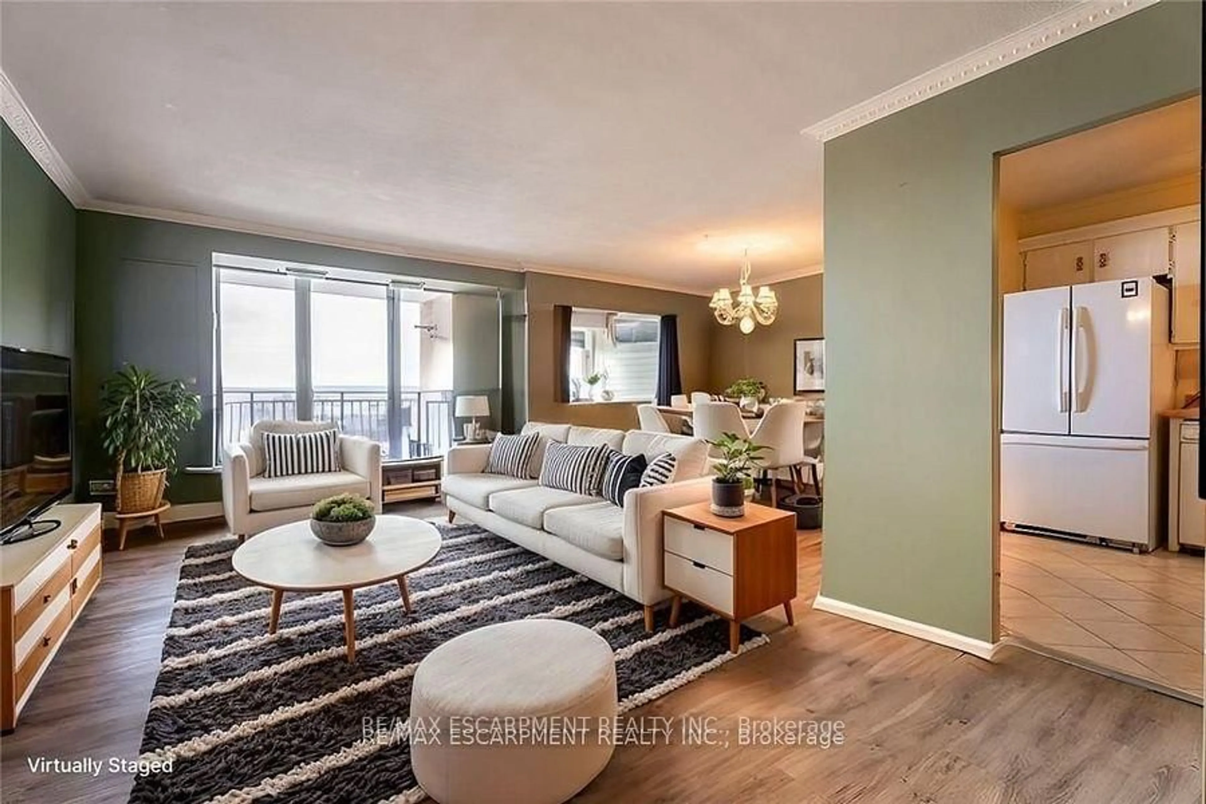 Living room with furniture, wood/laminate floor for 500 Green Rd #1206, Hamilton Ontario L8E 3M6