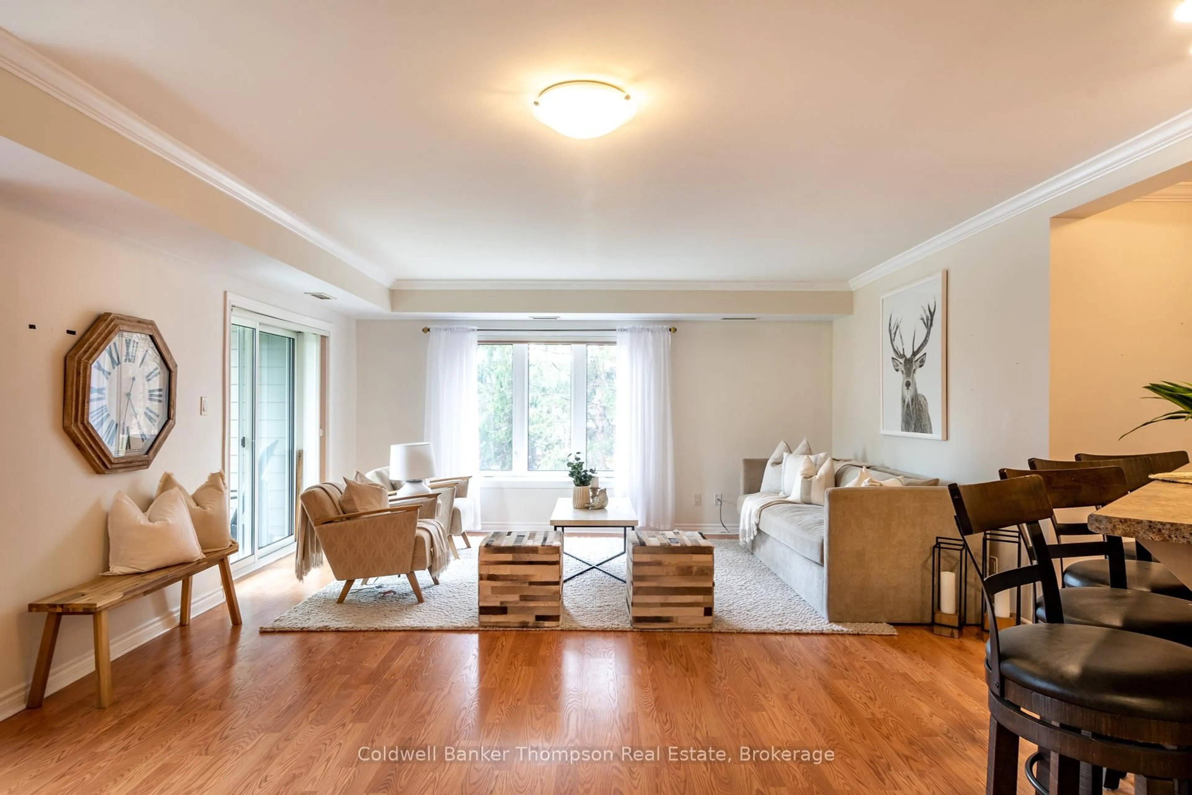 Living room with furniture, wood/laminate floor for 24 Dairy Lane #101, Huntsville Ontario P1H 0A4