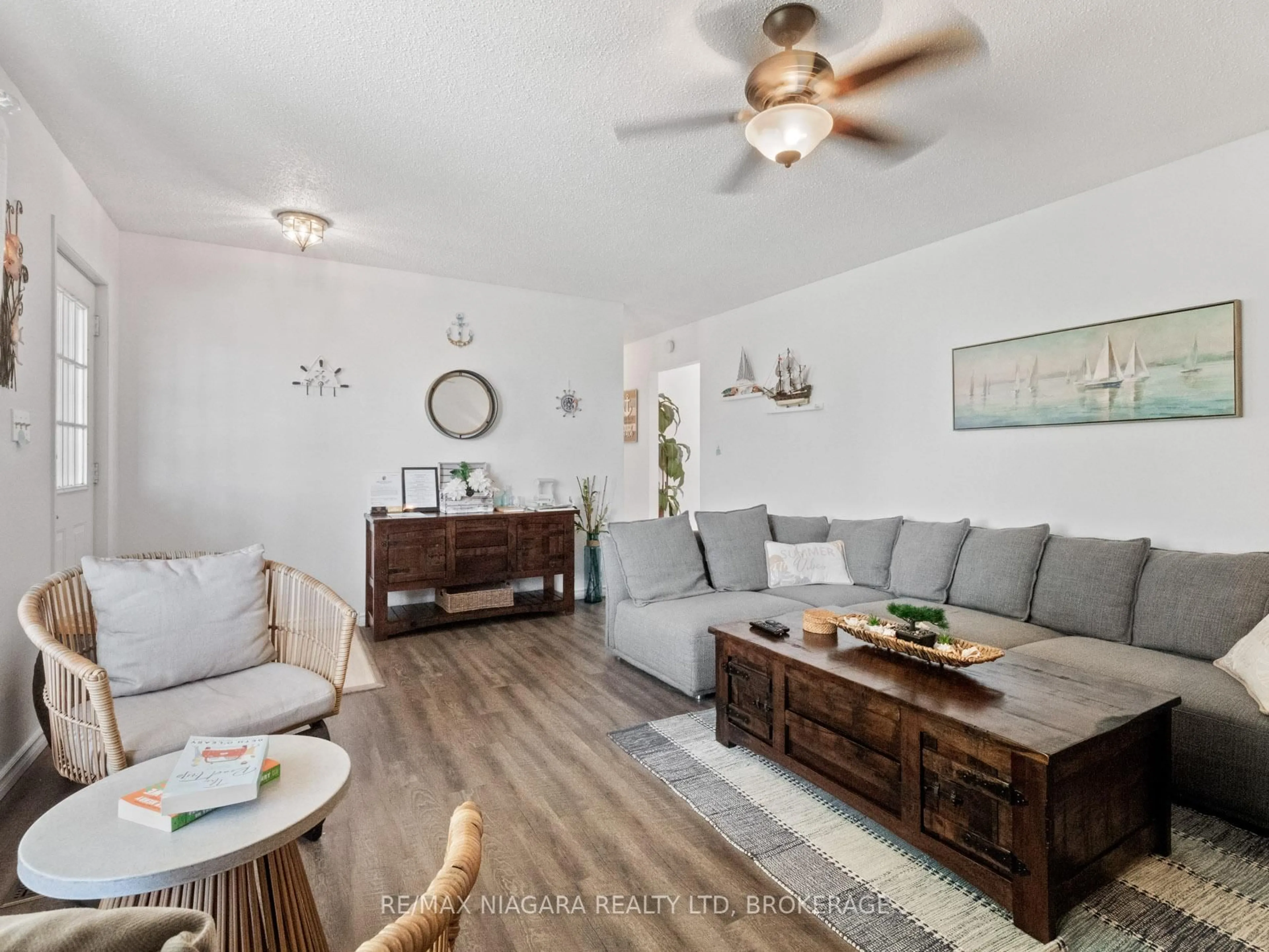 Living room with furniture, wood/laminate floor for 150 Elmwood Ave, Fort Erie Ontario L0S 1B0