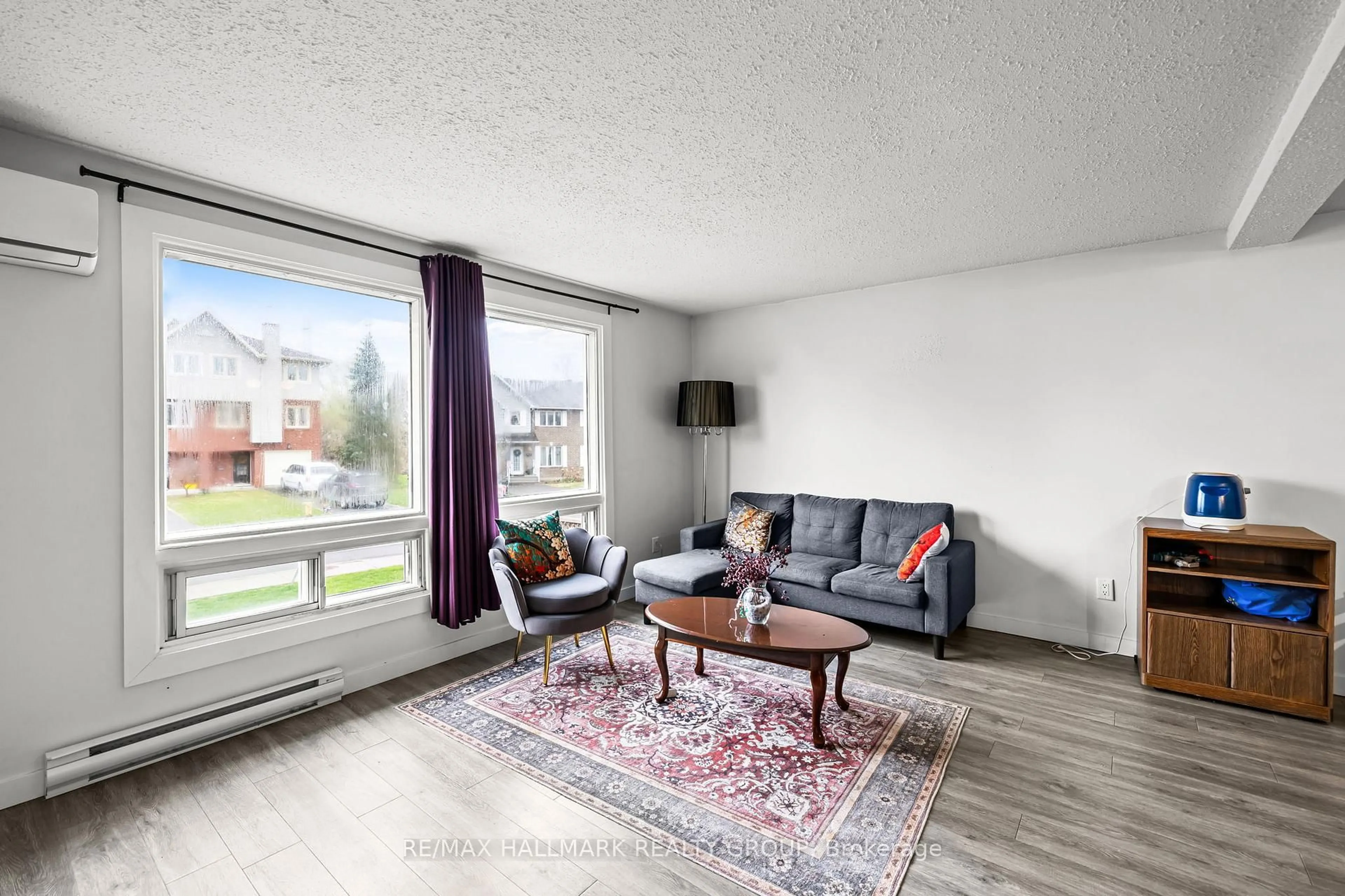 Living room with furniture, wood/laminate floor for 135 Glamorgan Dr, Kanata Ontario K2L 1R7