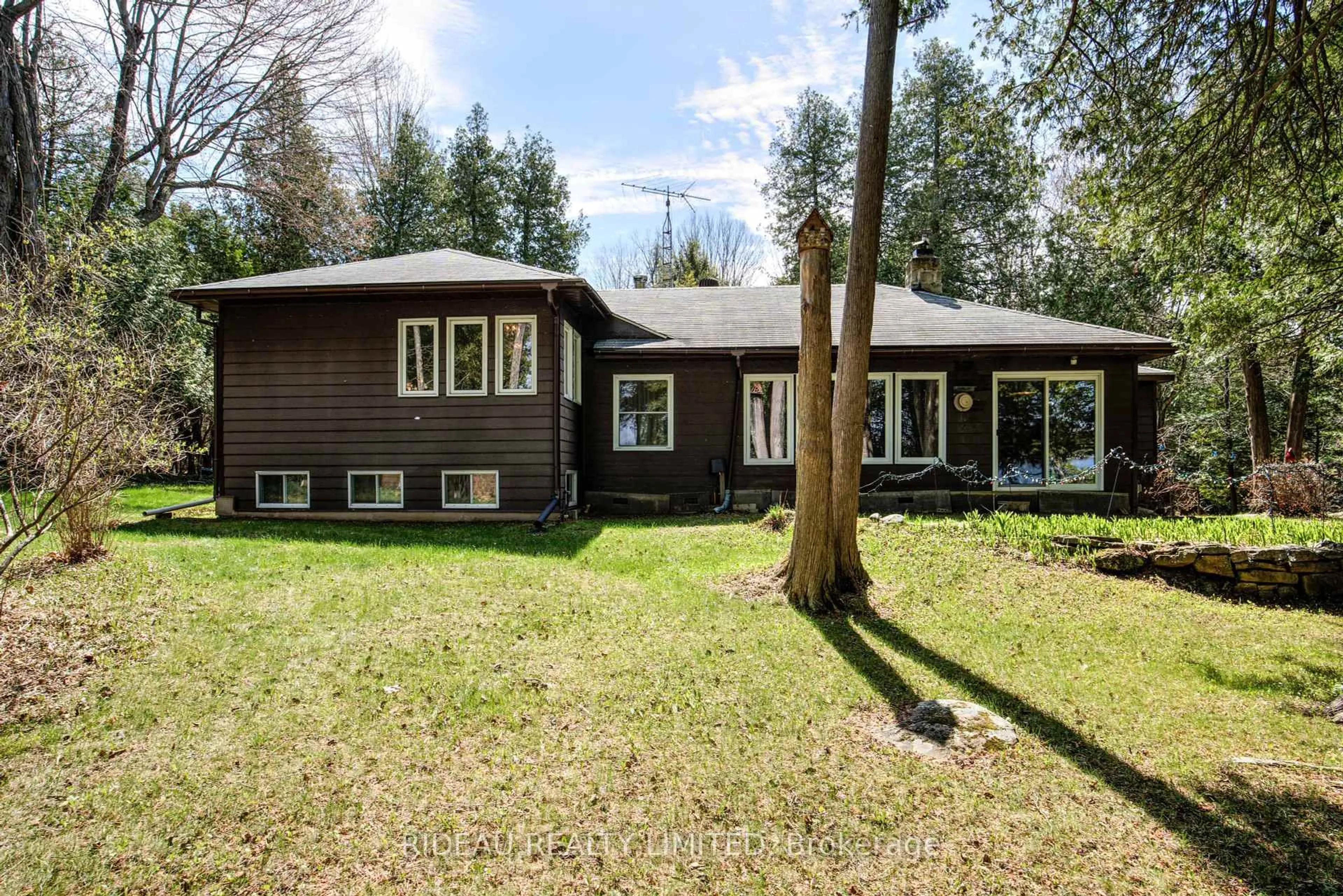 Home with vinyl exterior material, forest/trees view for 3801A Big Rideau Lake Rd, Rideau Lakes Ontario K0G 1V0