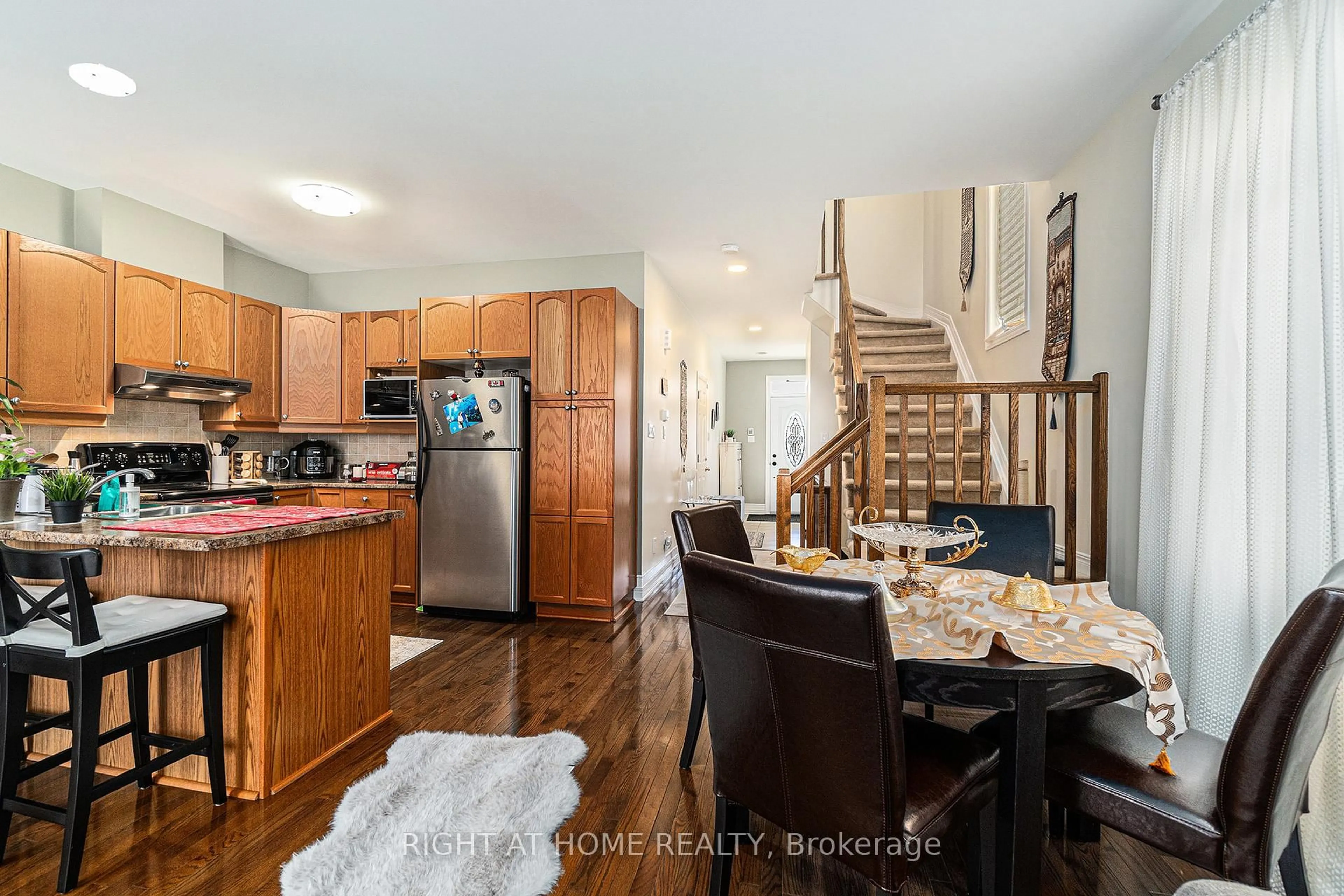 Open concept kitchen, wood/laminate floor for 174 Parkin Circ, Ottawa Ontario K1T 4G4