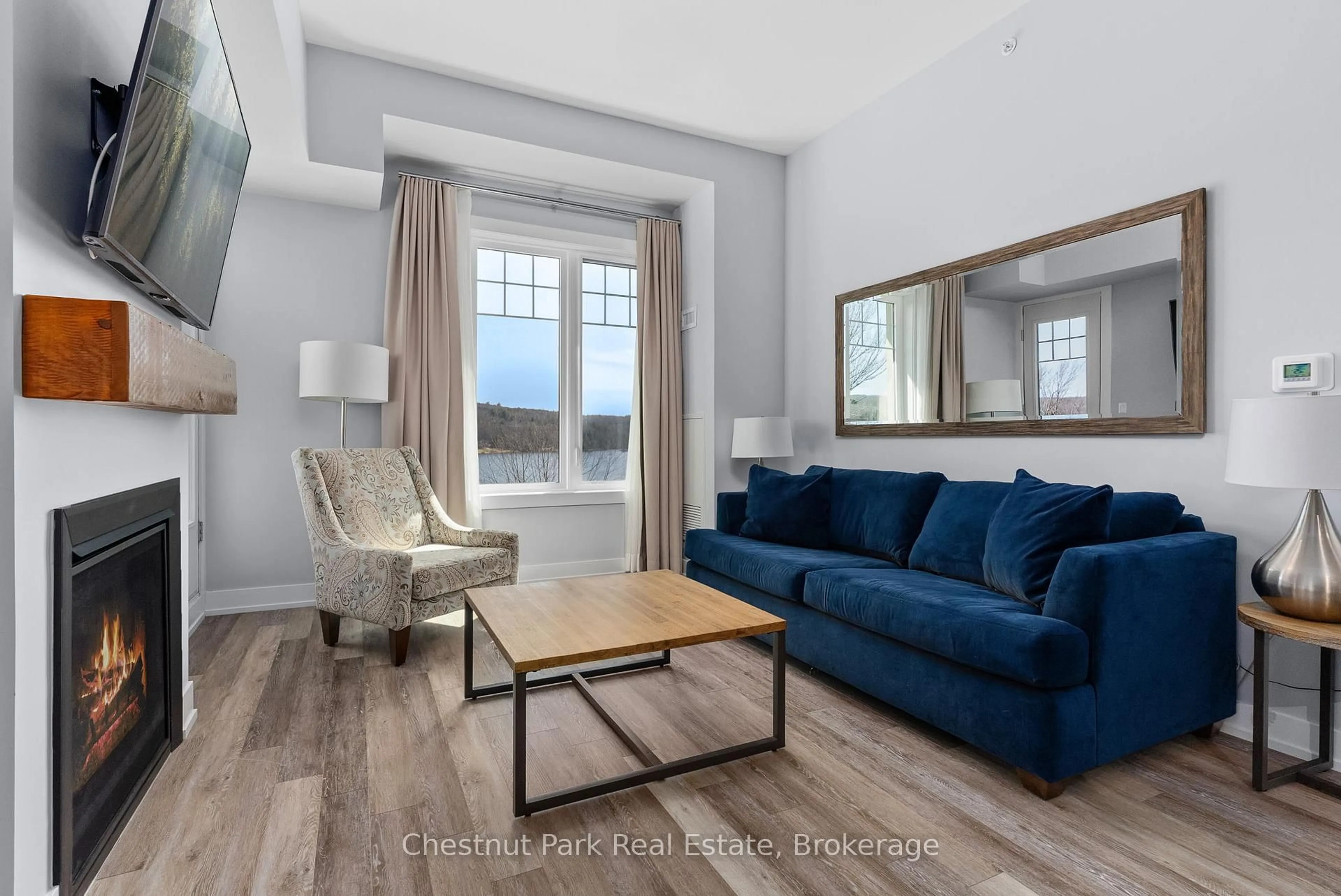 Living room with furniture, wood/laminate floor for 25 Pen Lake Point Rd #117, Huntsville Ontario P1H 1A9