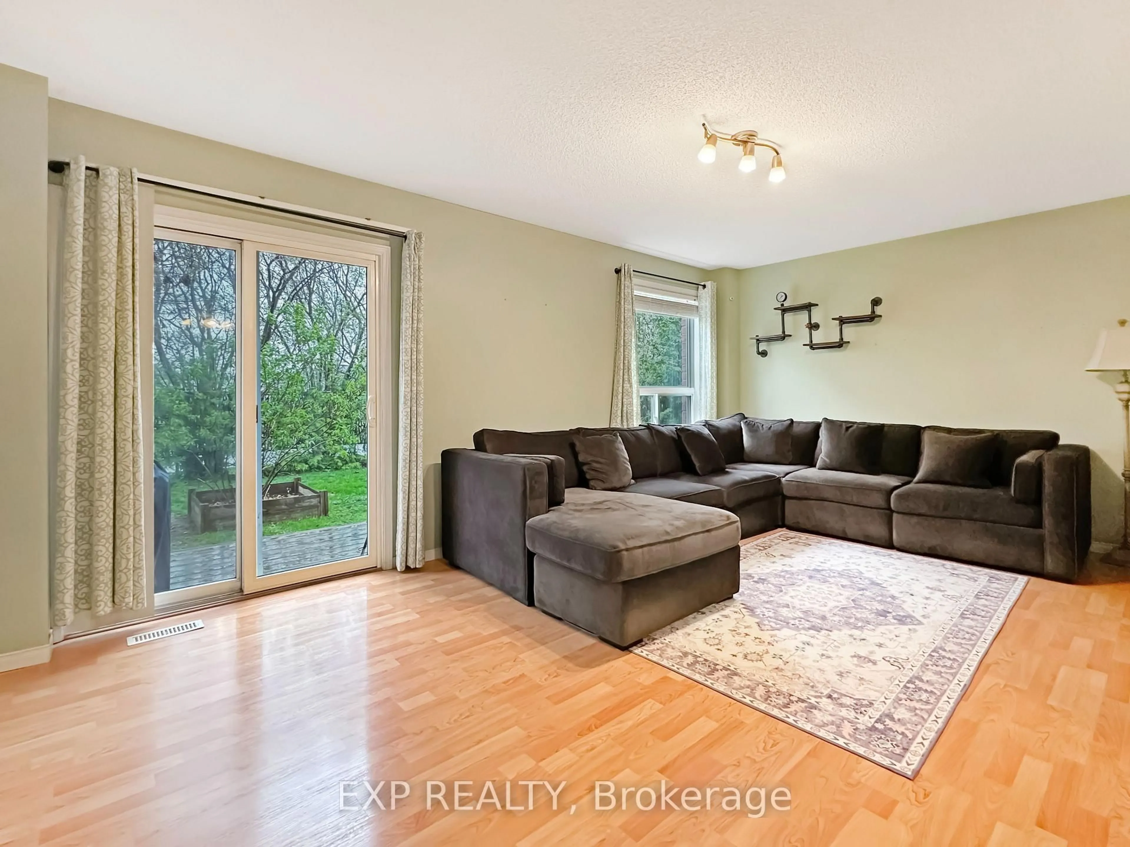 Living room with furniture, wood/laminate floor for 880 Marigold St, London North Ontario N5X 4G8