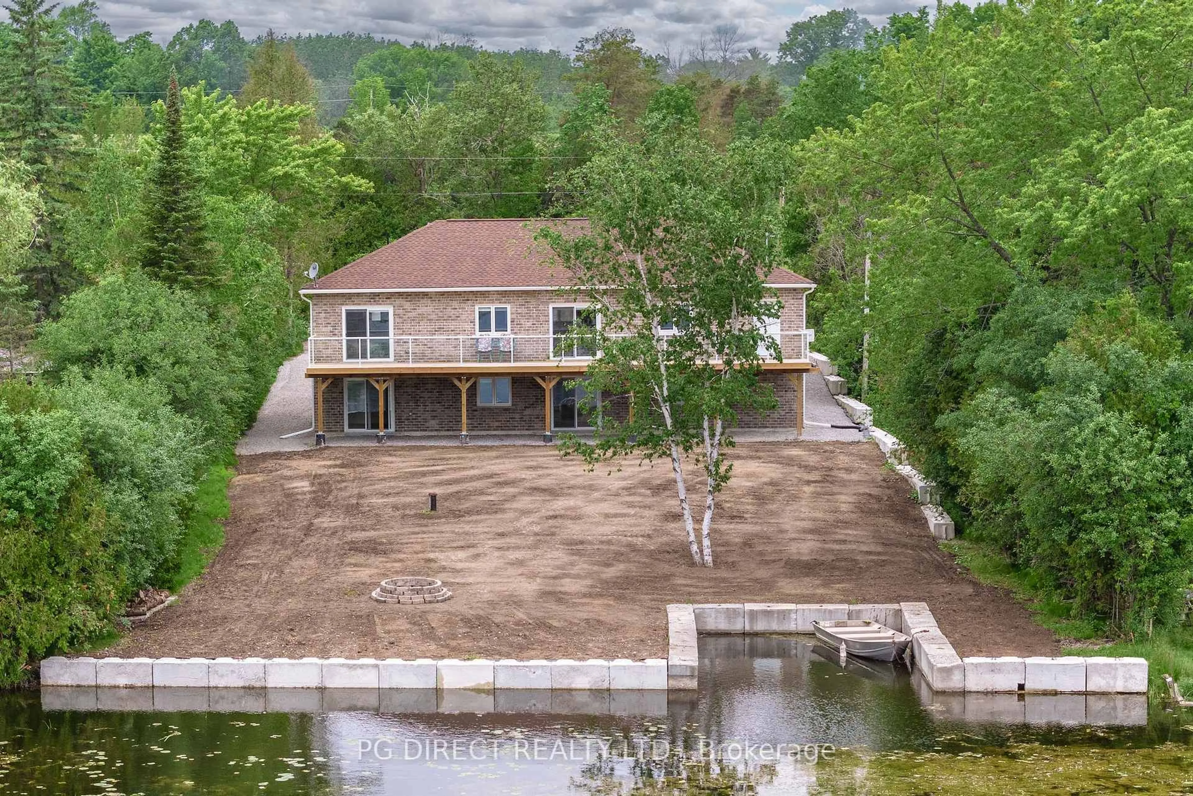 A pic from outside/outdoor area/front of a property/back of a property/a pic from drone, water/lake/river/ocean view for 12 Evergreen St, Kawartha Lakes Ontario K0L 2W0