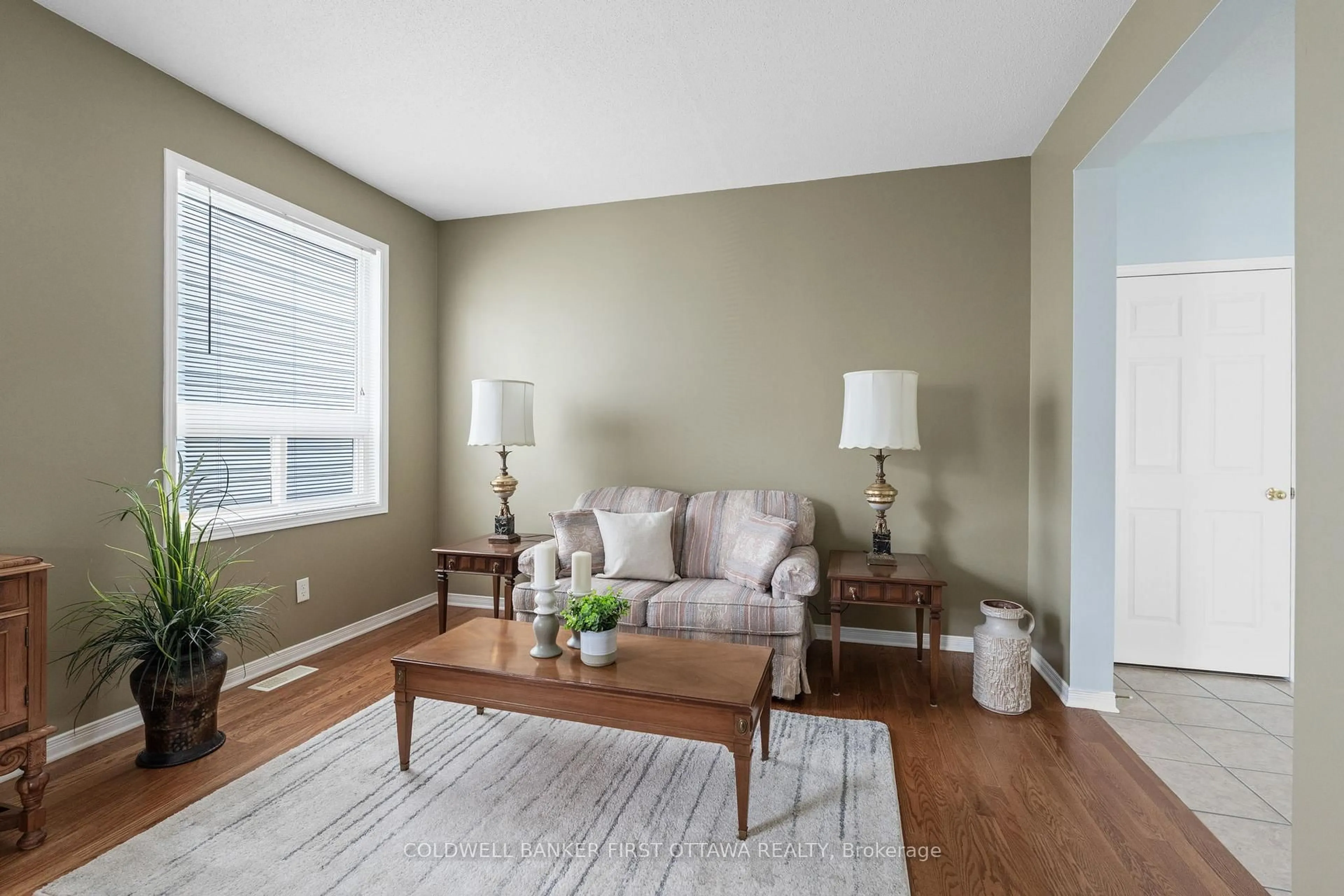 Living room with furniture, wood/laminate floor for 244 Deercroft Ave, Ottawa Ontario K2J 5J9