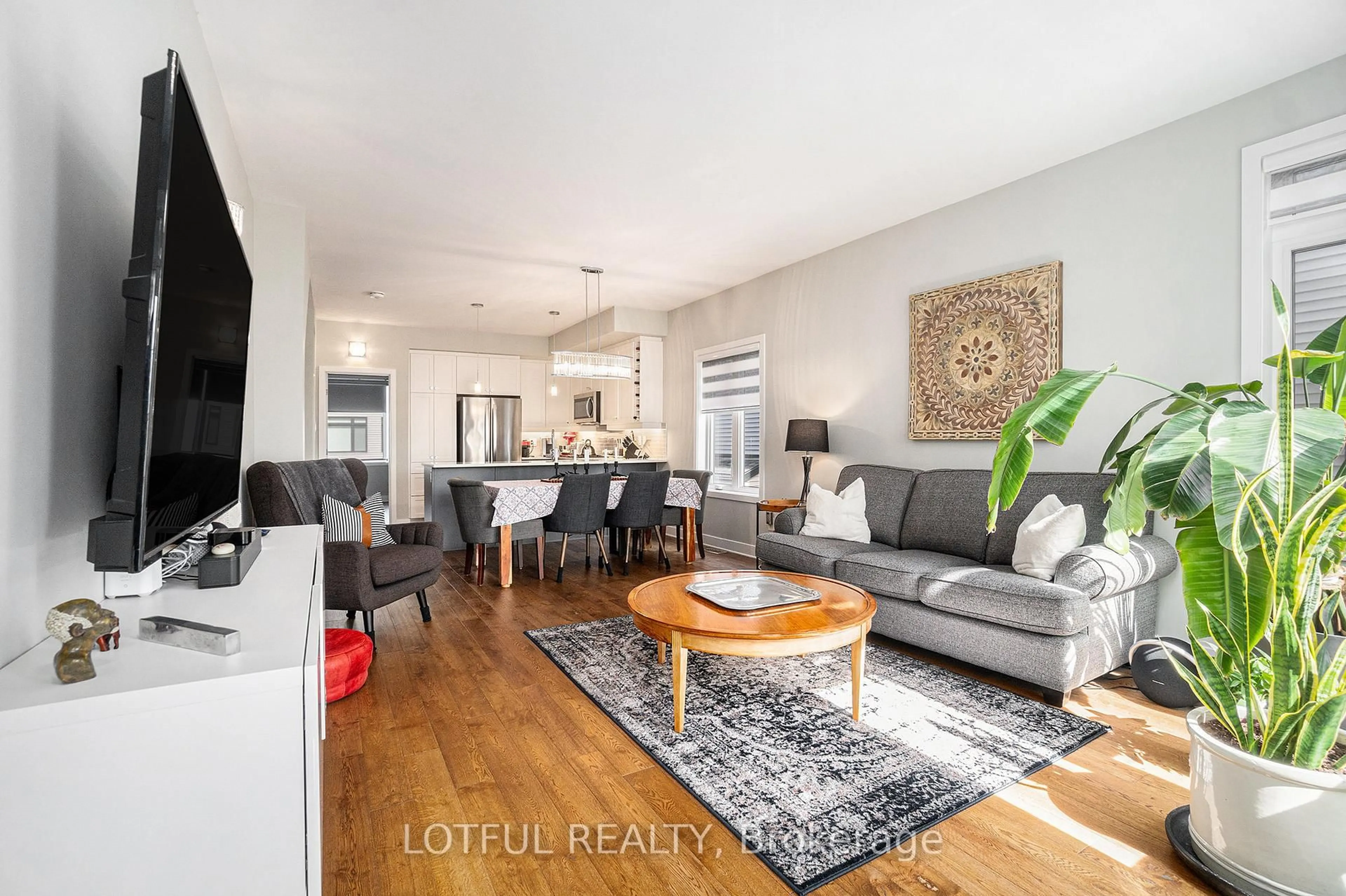 Living room with furniture, wood/laminate floor for 534 Crescendo Private N/A #34, Ottawa Ontario K1X 0E4