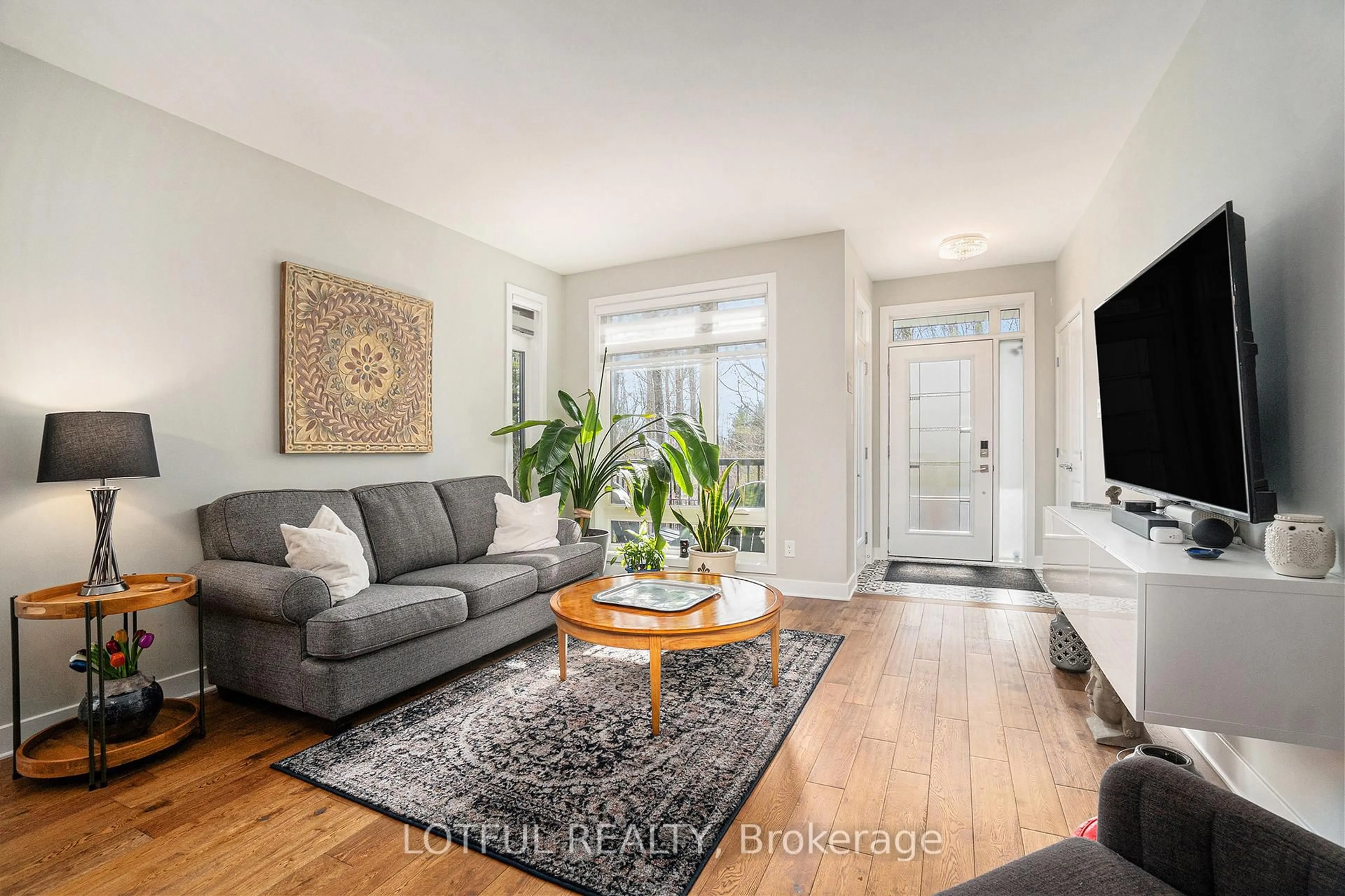 Living room with furniture, wood/laminate floor for 534 Crescendo Private N/A #34, Ottawa Ontario K1X 0E4