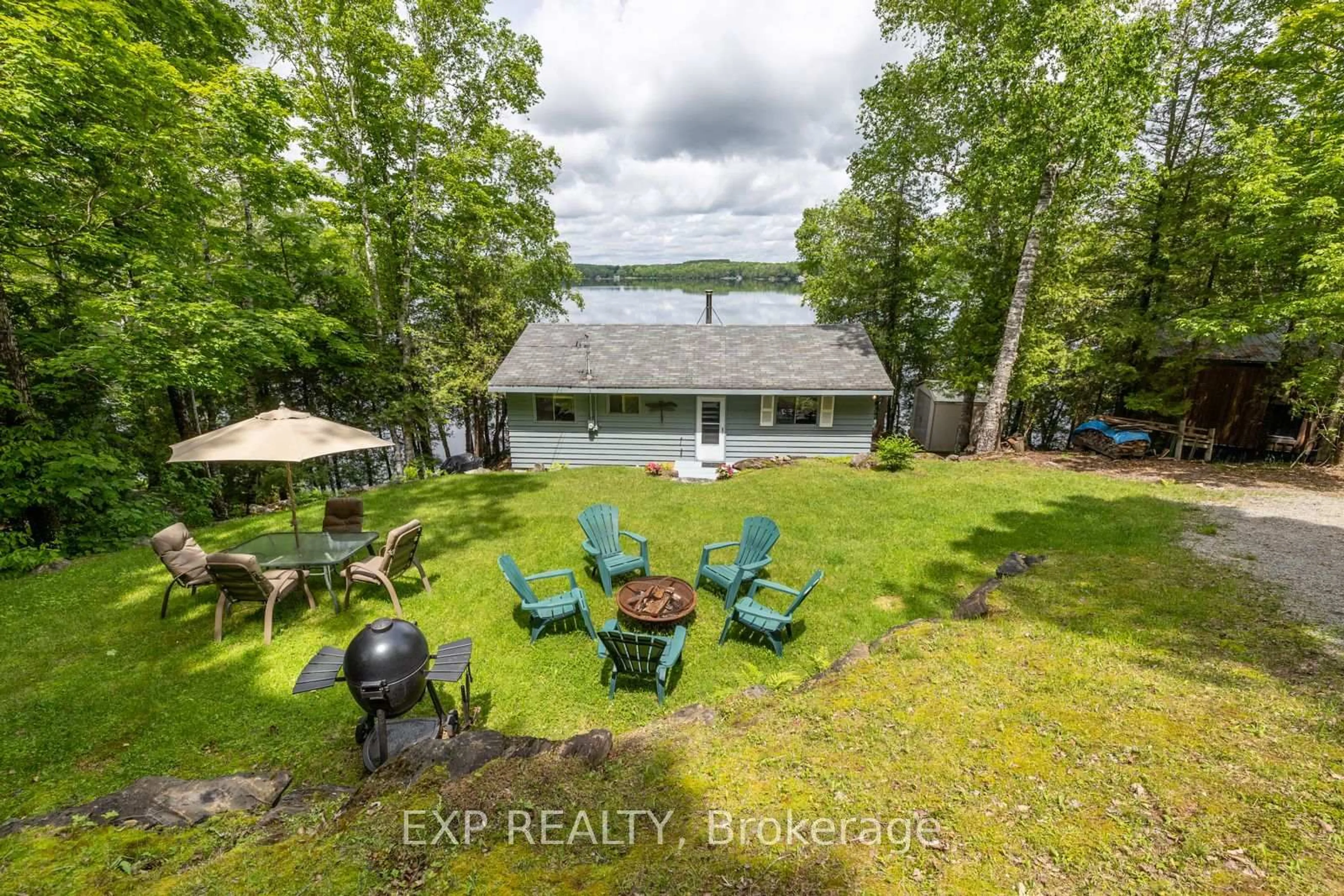 A pic from outside/outdoor area/front of a property/back of a property/a pic from drone, water/lake/river/ocean view for 400B Gilbert Bay Lane, Coe Hill Ontario K0L 1P0