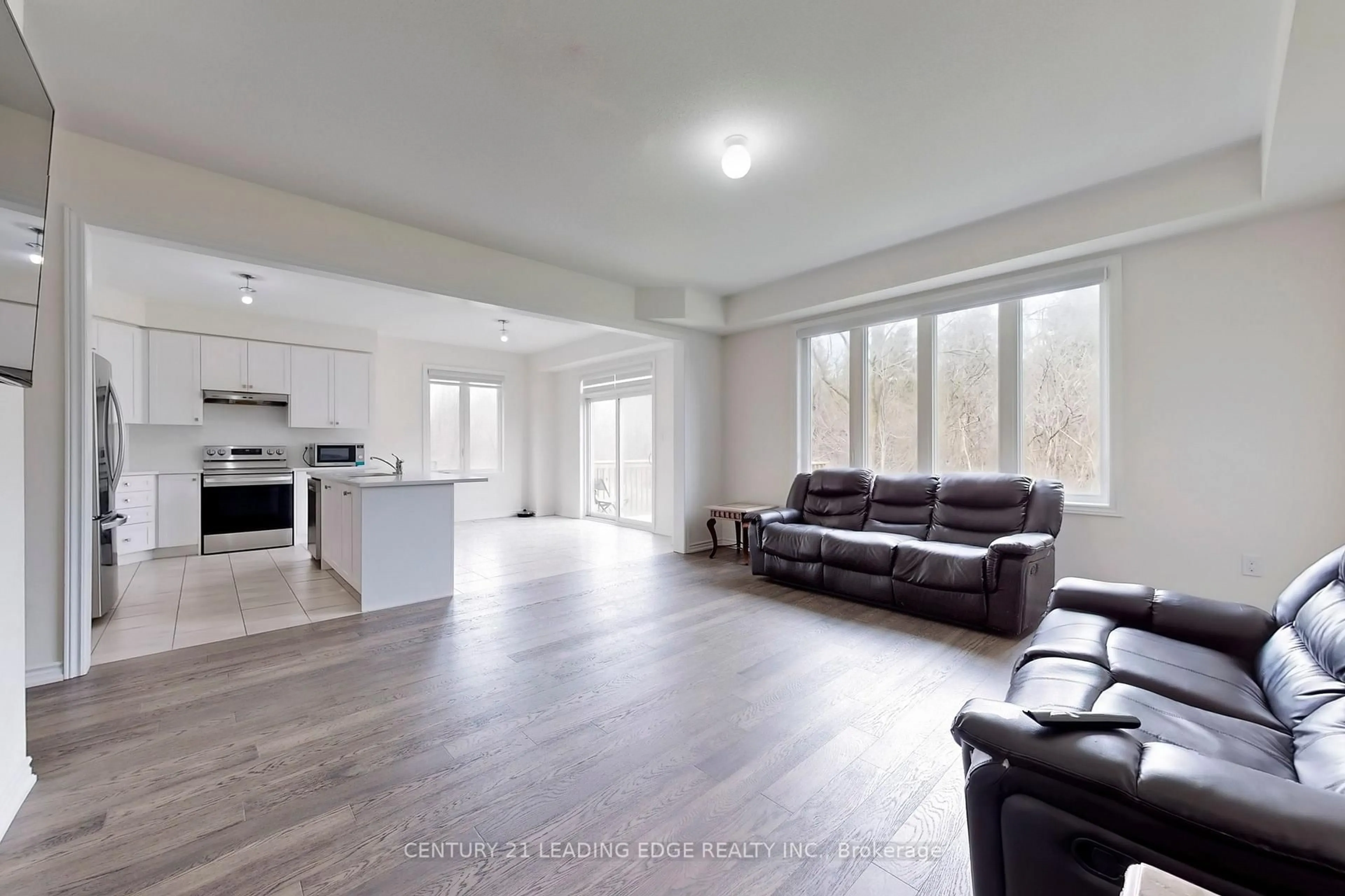 Living room with furniture, wood/laminate floor for 630 Lemay Grve, Peterborough North Ontario K9K 0G9