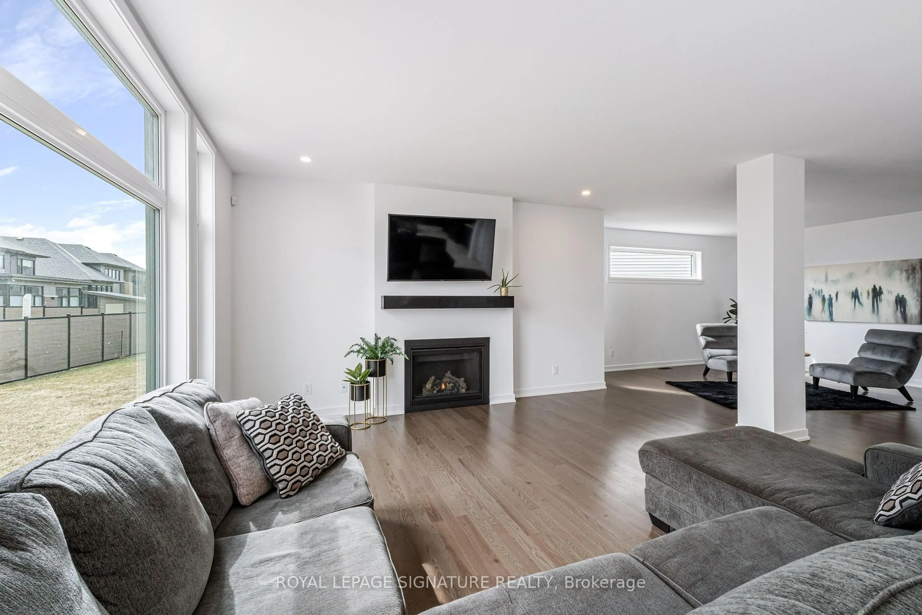 Living room with furniture, wood/laminate floor for 117 Orchestra Way, Ottawa Ontario K4M 0R5