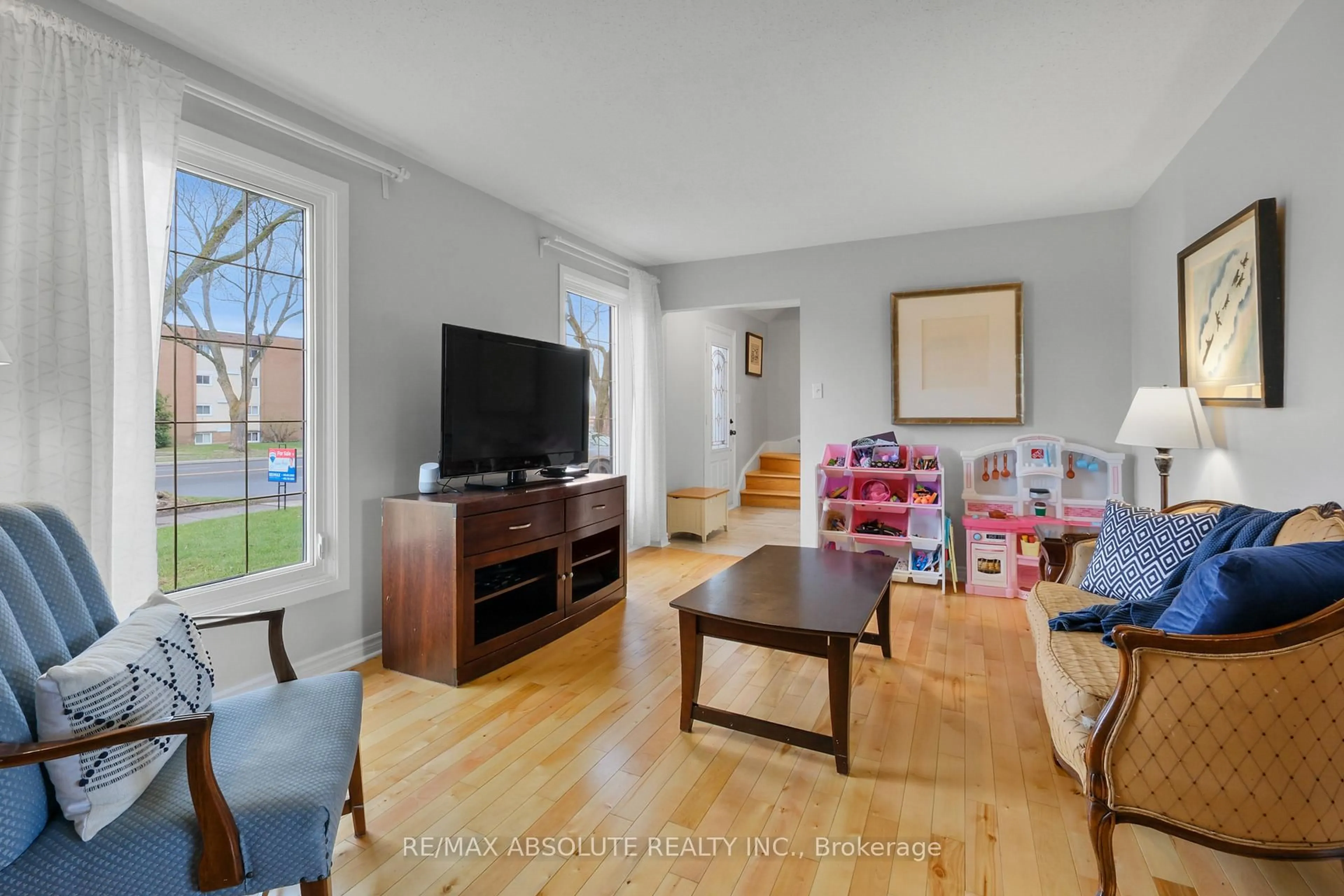 Living room with furniture, wood/laminate floor for 2342 Ogilvie Rd, Ottawa Ontario K1J 7N6