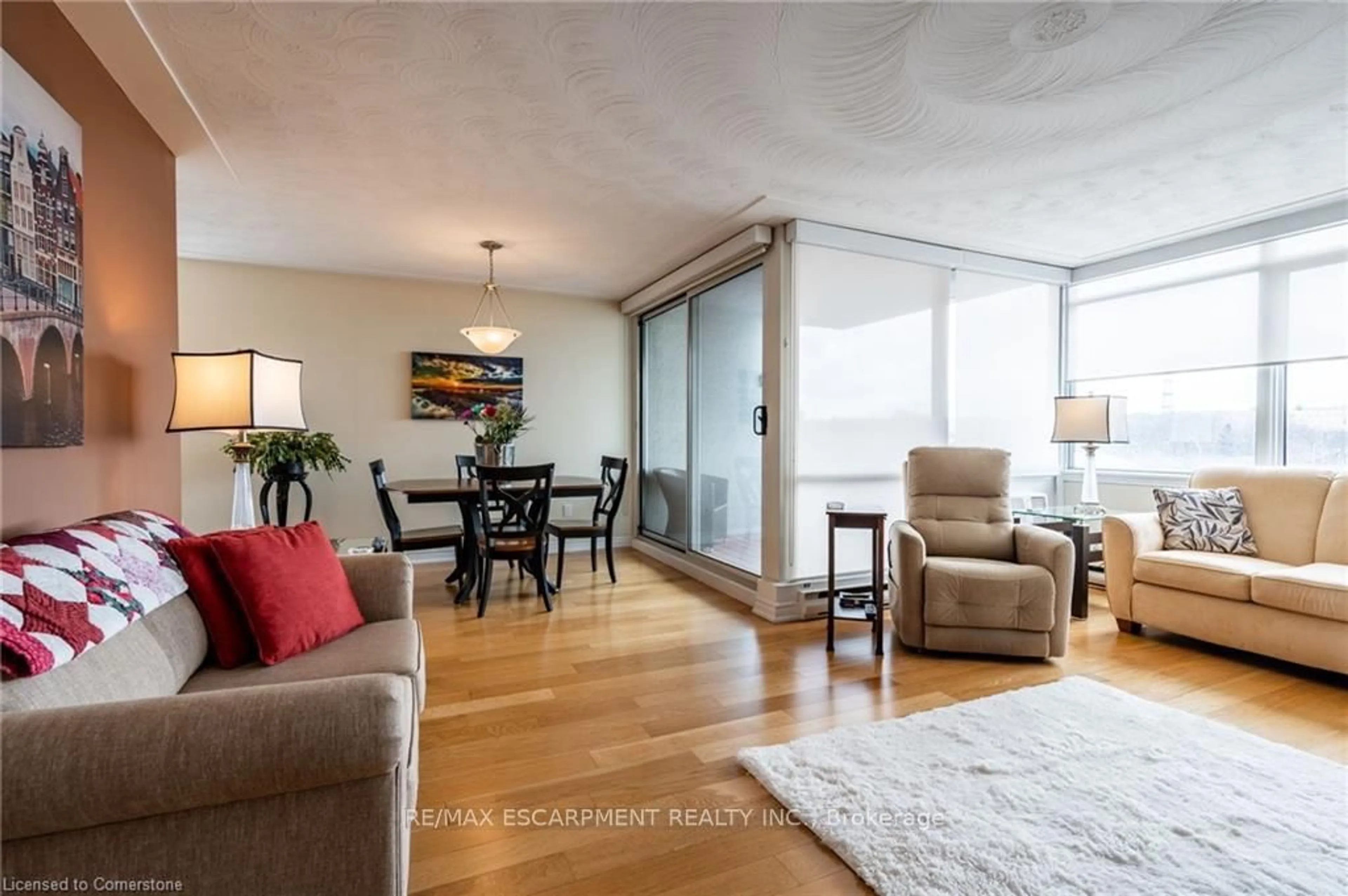Living room with furniture, wood/laminate floor for 40 Harrisford St #402, Hamilton Ontario L8K 6N1