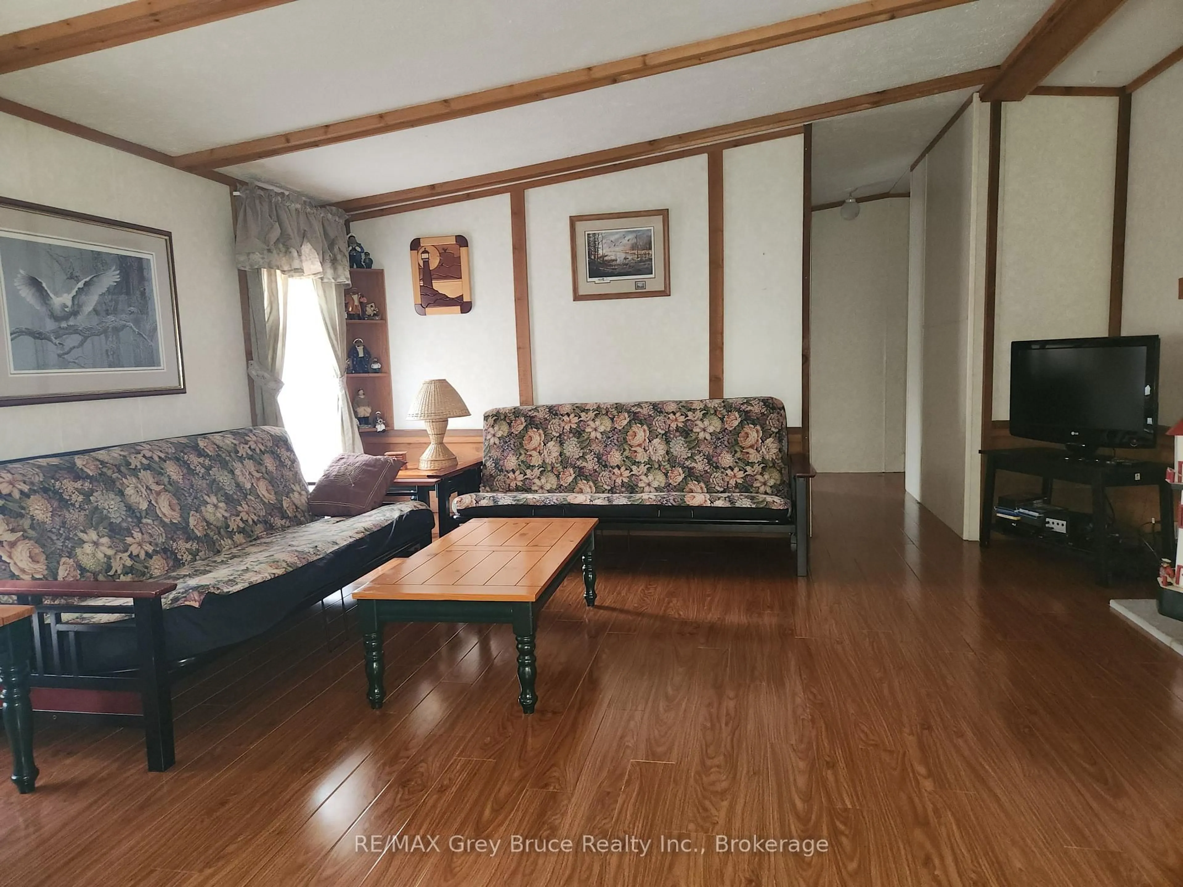 Living room with furniture, wood/laminate floor for 41 Maple Dr, Northern Bruce Peninsula Ontario N0H 1Z0