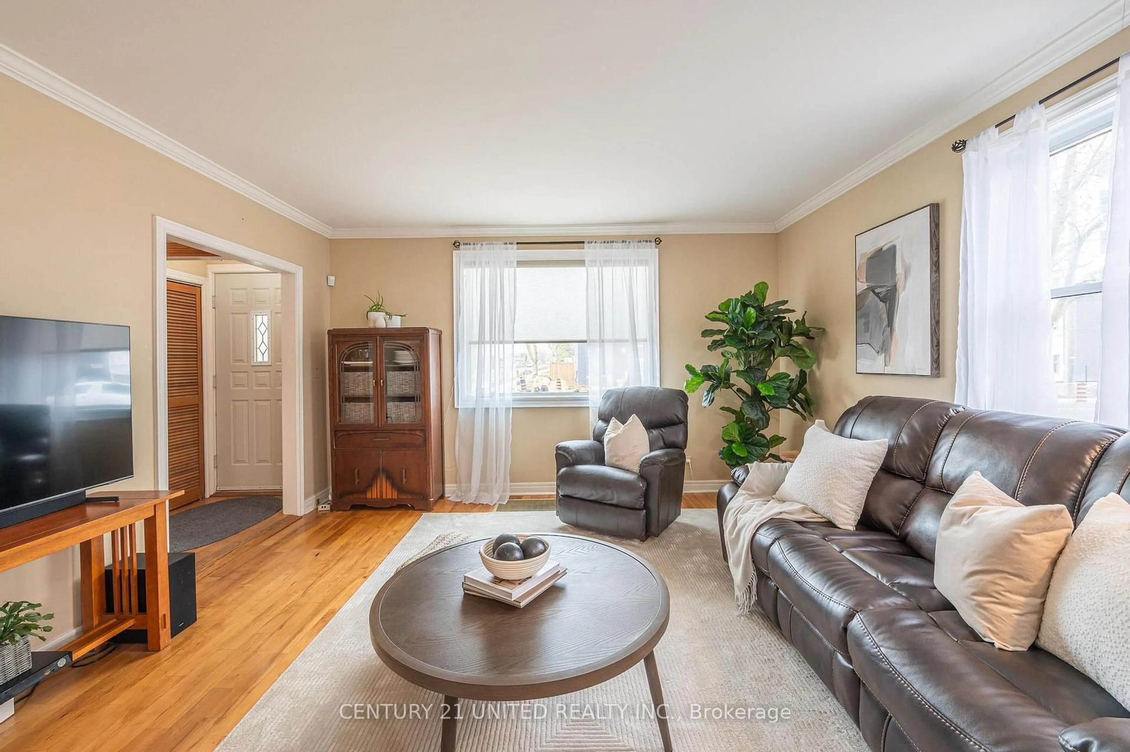 Living room with furniture, wood/laminate floor for 654 Monaghan Rd, Peterborough South Ontario K9J 5J4