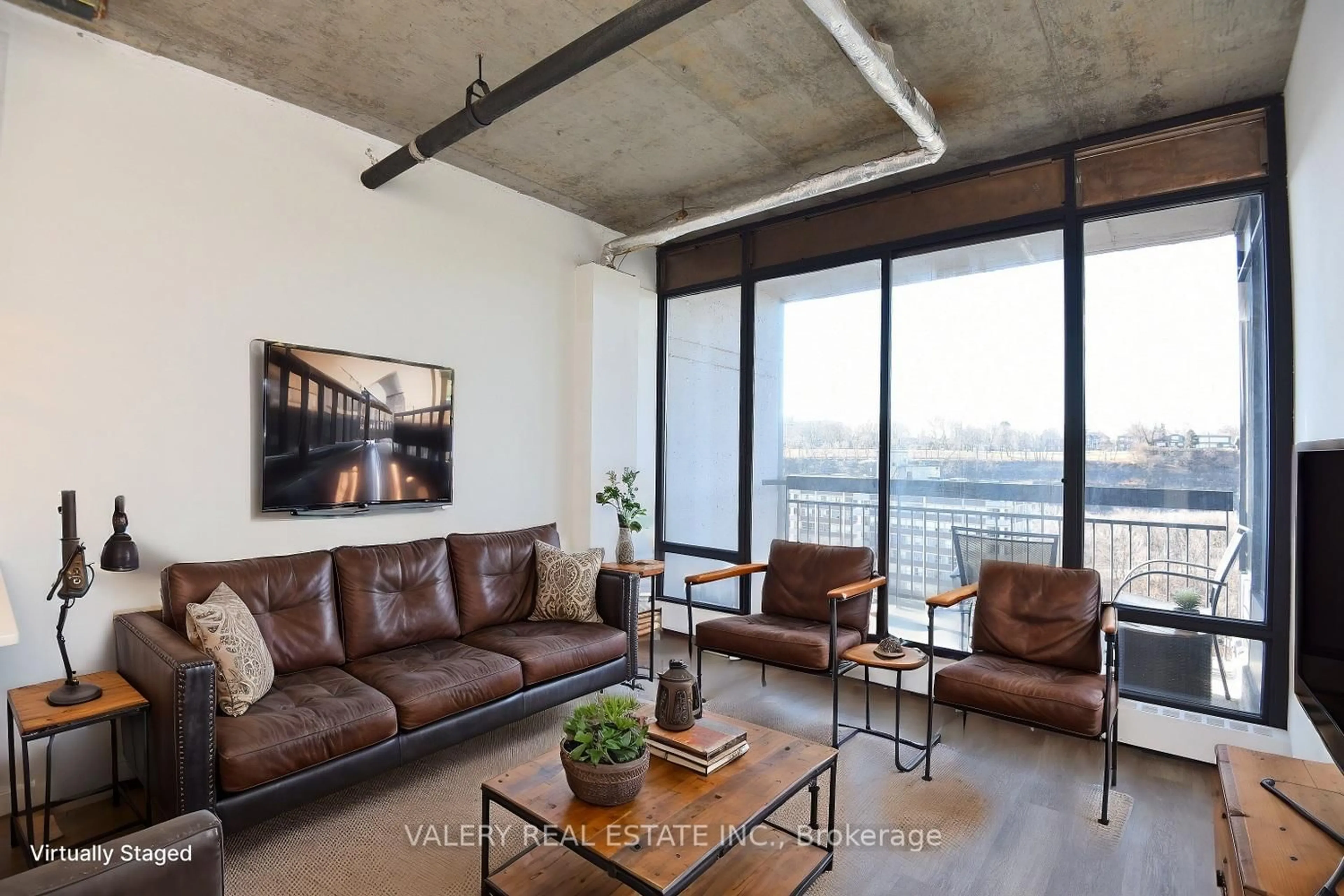 Living room with furniture, cement floor for 150 Charlton Ave #3305, Hamilton Ontario L8N 3X3