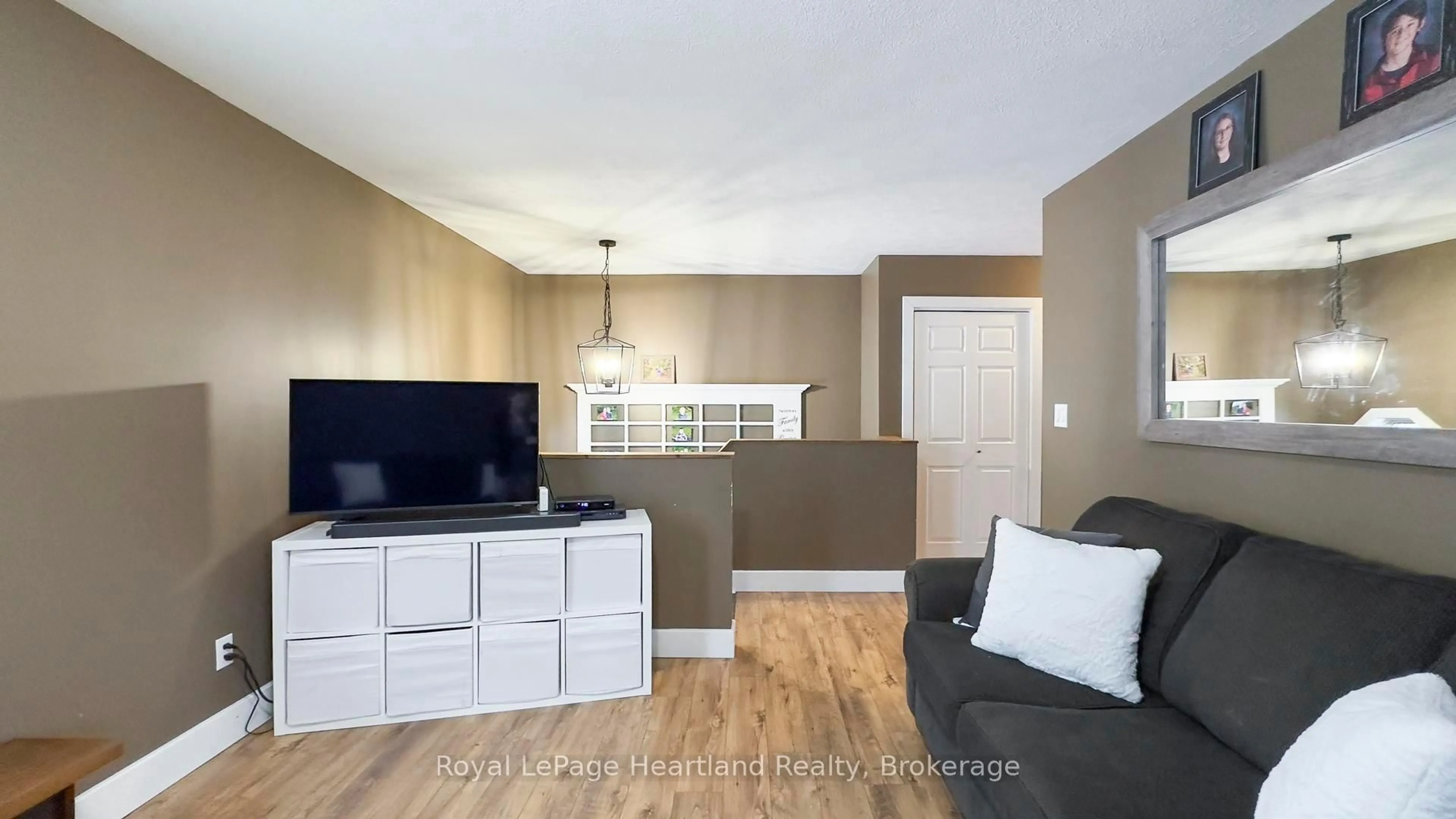 Living room with furniture, wood/laminate floor for 223 Bennett St, Goderich Ontario N7A 1A8