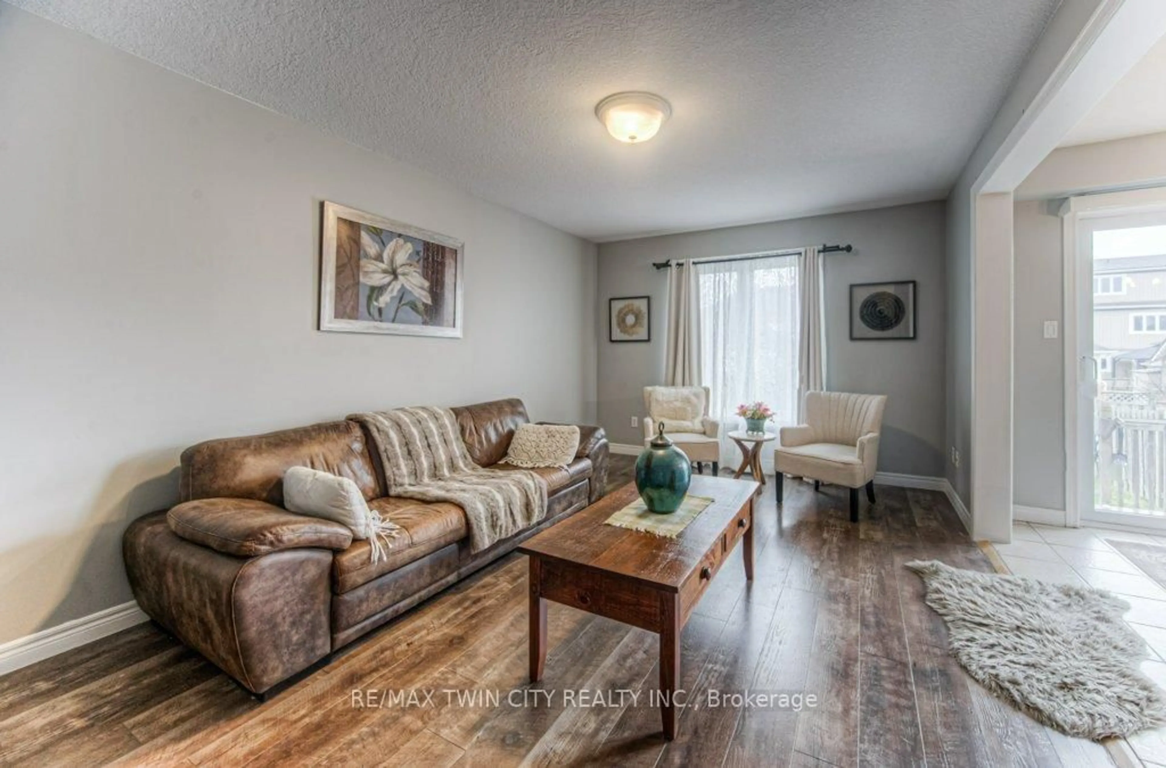 Living room with furniture, wood/laminate floor for 691 Karlsfeld Rd, Waterloo Ontario N2T 2V3