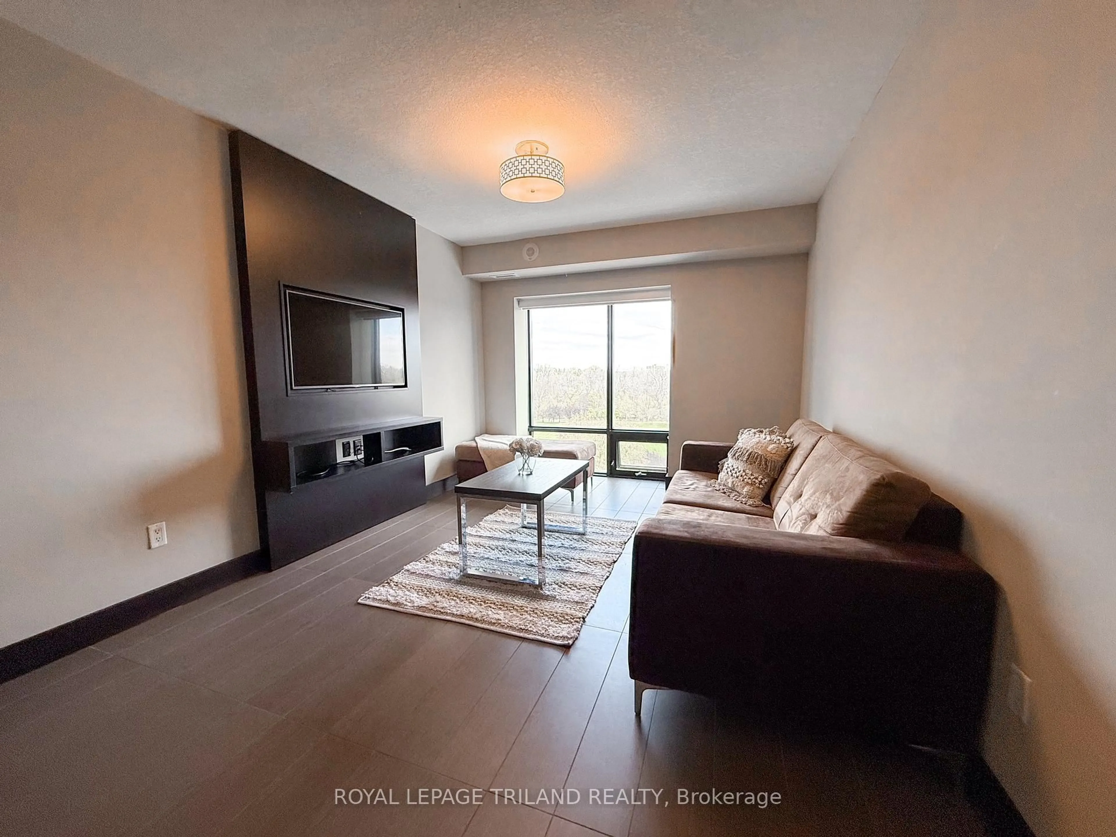 Living room with furniture, wood/laminate floor for 1235 RICHMOND St #806, London East Ontario N6A 0C1