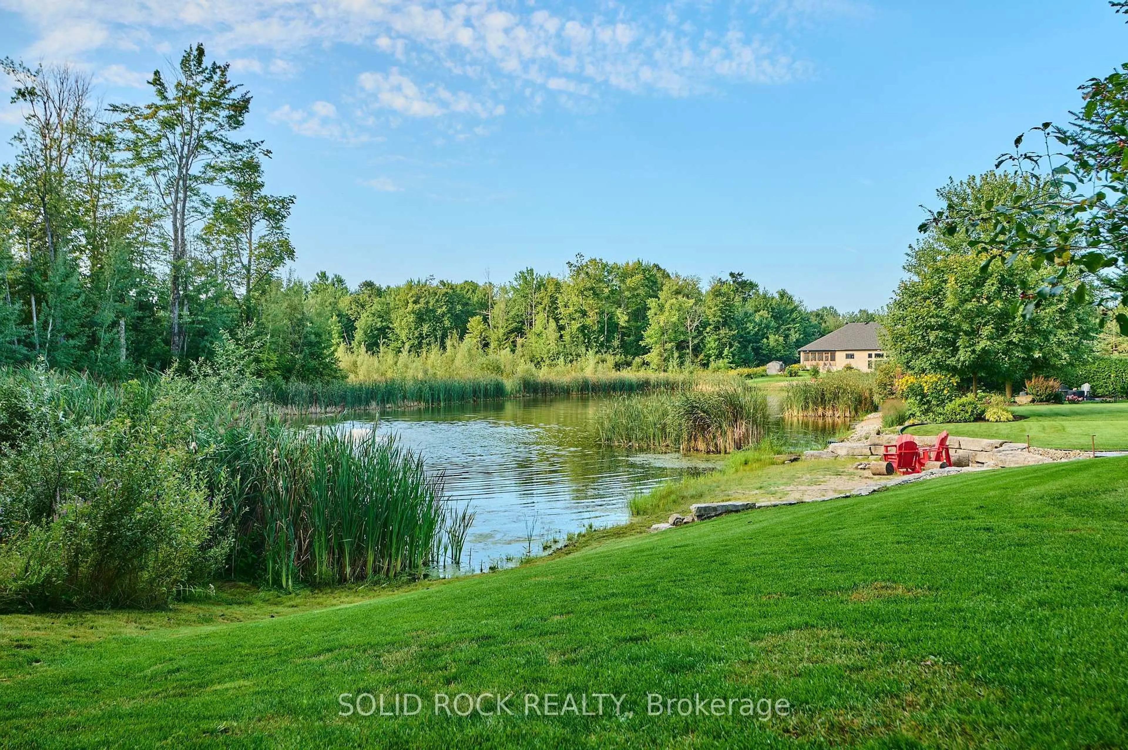 A pic from outside/outdoor area/front of a property/back of a property/a pic from drone, water/lake/river/ocean view for 1882 Cedarlakes Way, Ottawa Ontario K4P 0E4