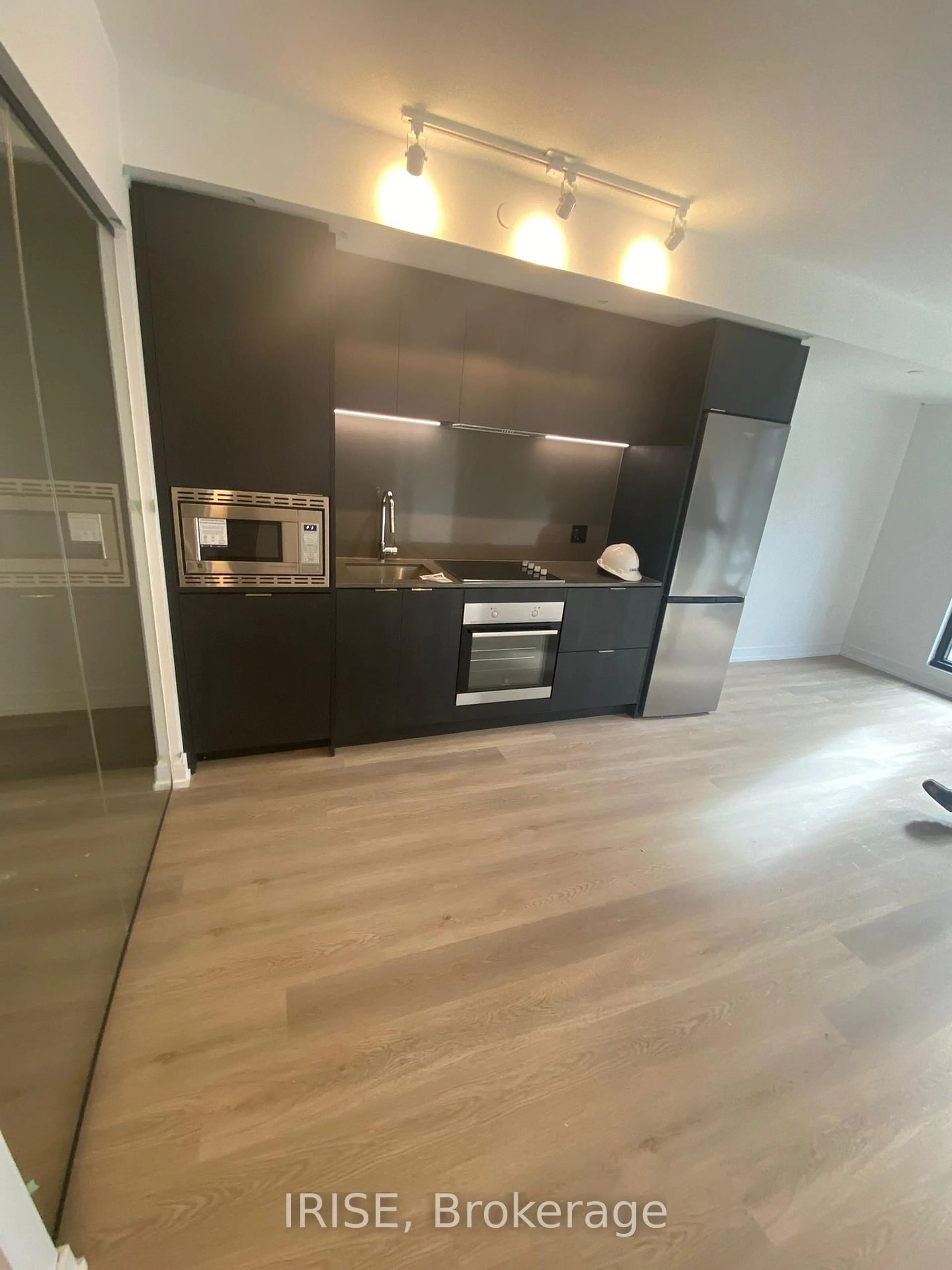 Open concept kitchen, wood/laminate floor for 1 Jarvis St #306, Hamilton Ontario L8R 3J2