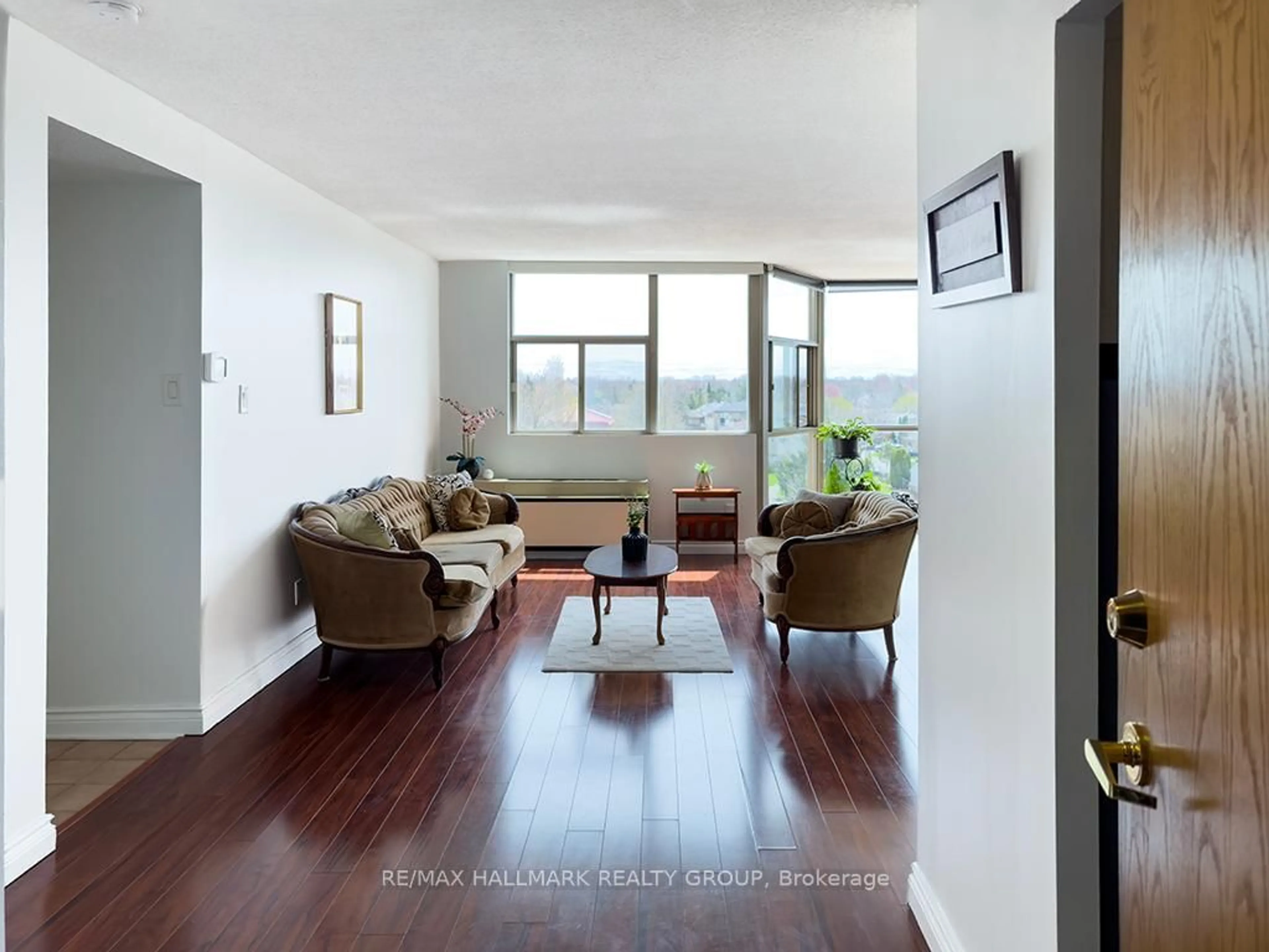 Living room with furniture, wood/laminate floor for 2760 Carousel Cres #707, Ottawa Ontario K1T 2N4