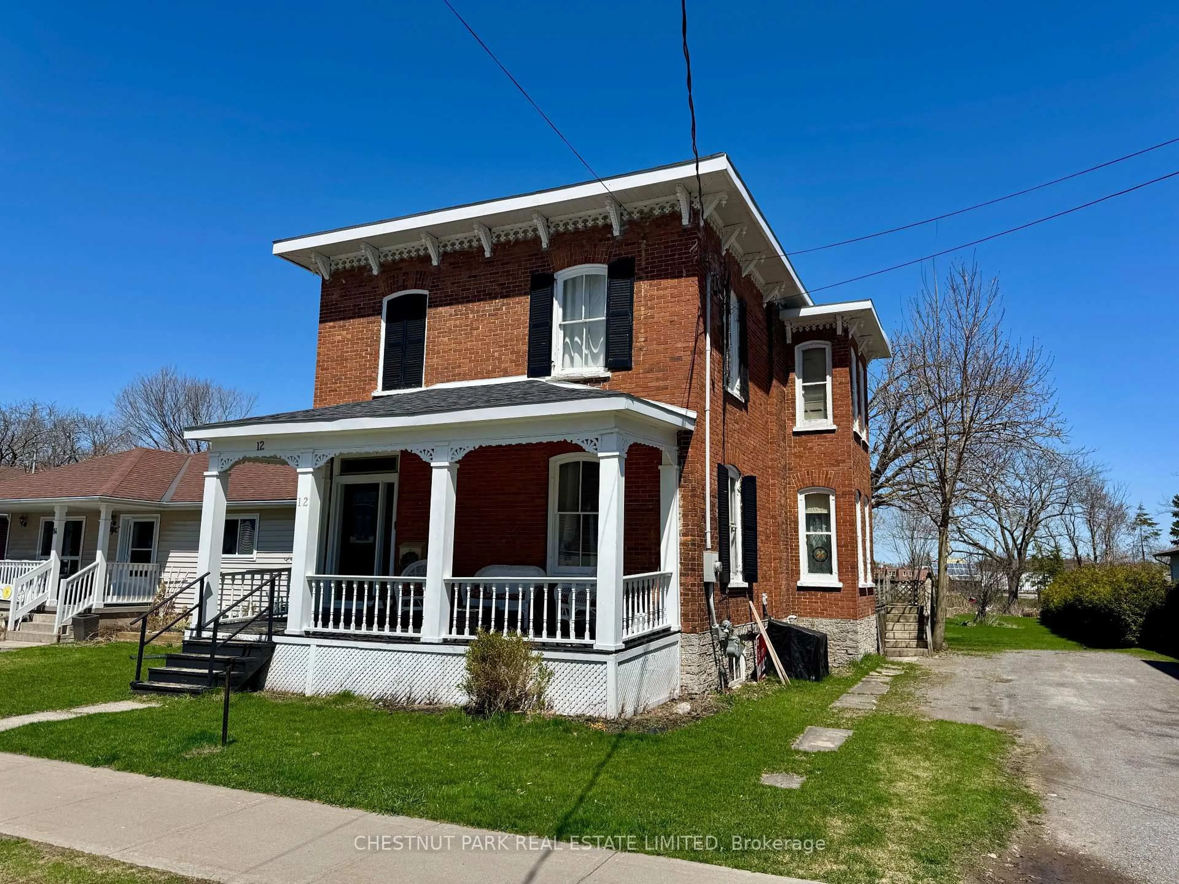 Home with brick exterior material, street for 12 Maple Ave, Prince Edward County Ontario K0K 2T0