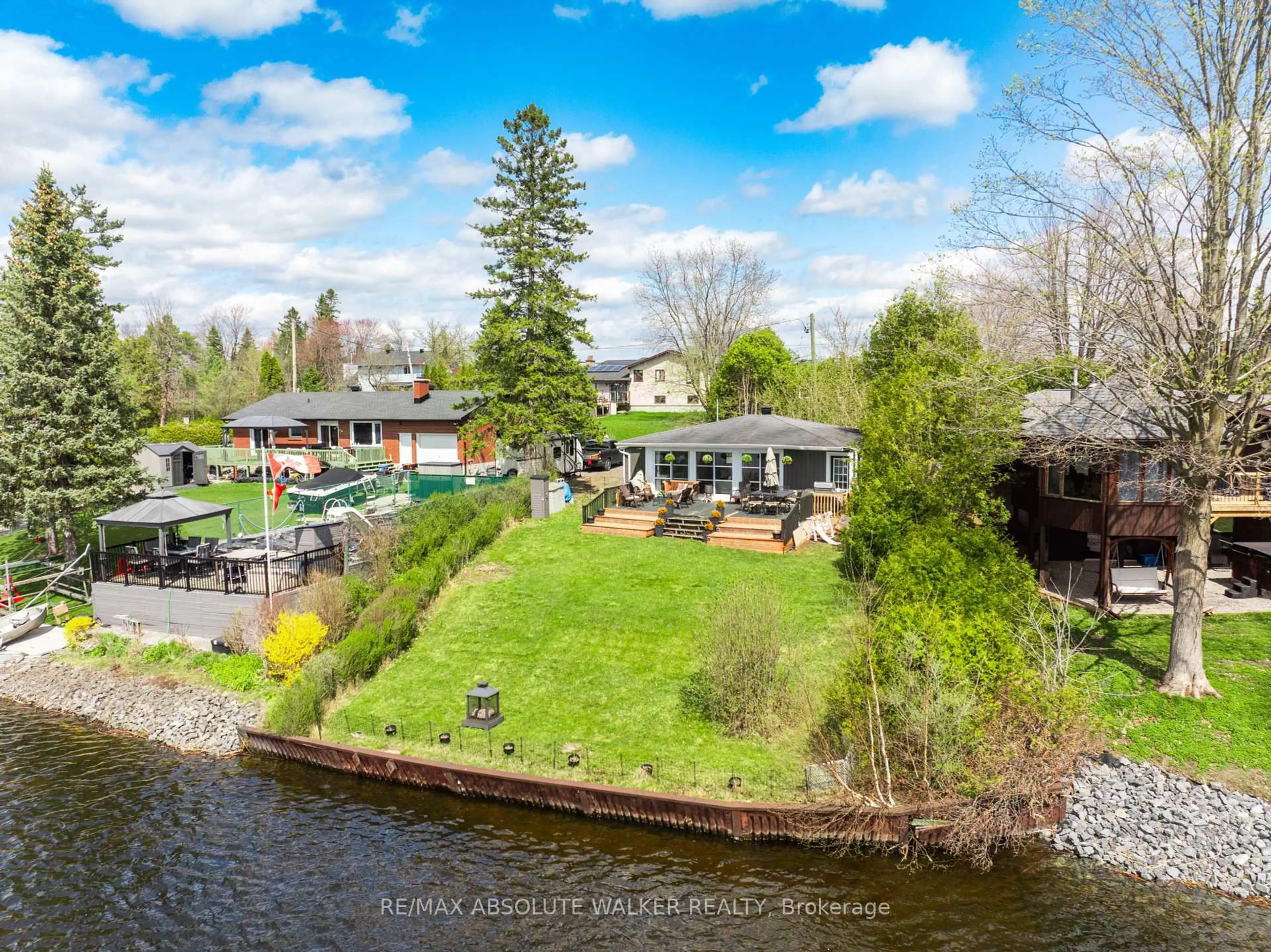 A pic from outside/outdoor area/front of a property/back of a property/a pic from drone, water/lake/river/ocean view for 2552C River Rd, Ottawa Ontario K4M 1B4