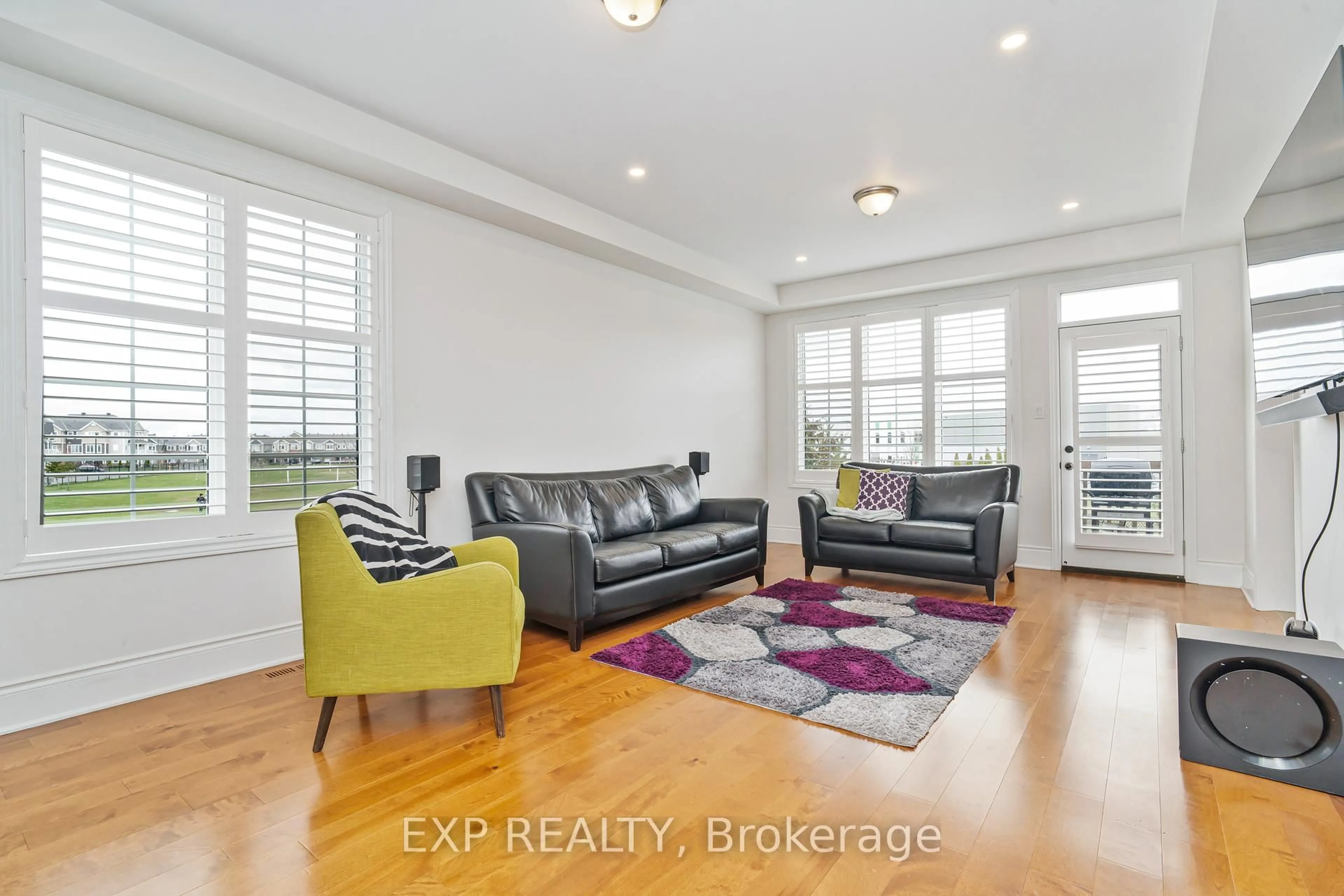 Living room with furniture, wood/laminate floor for 112 BURBOT St, Ottawa Ontario K2J 6J8