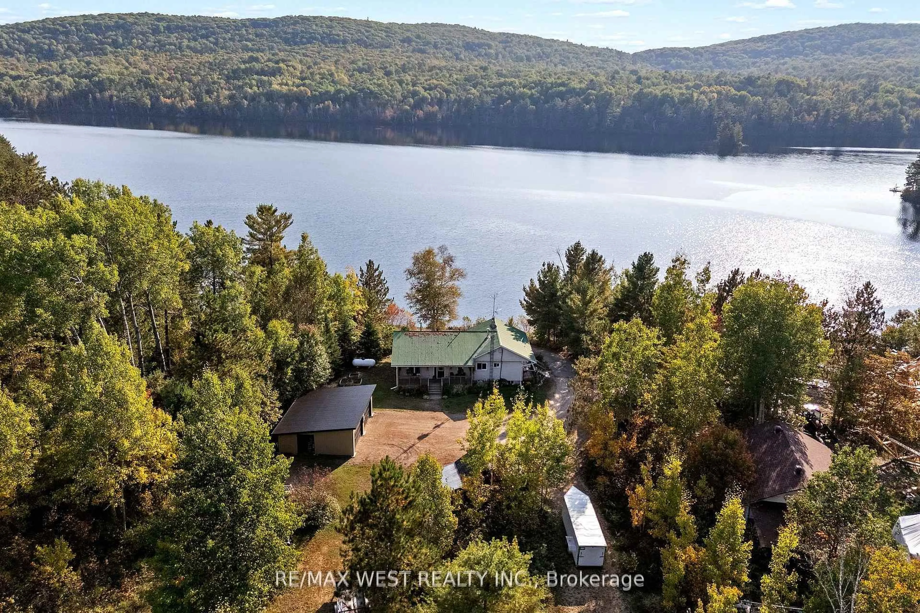 A pic from outside/outdoor area/front of a property/back of a property/a pic from drone, water/lake/river/ocean view for 558 Mccauley Lake Rd, South Algonquin Ontario K0J 2C0