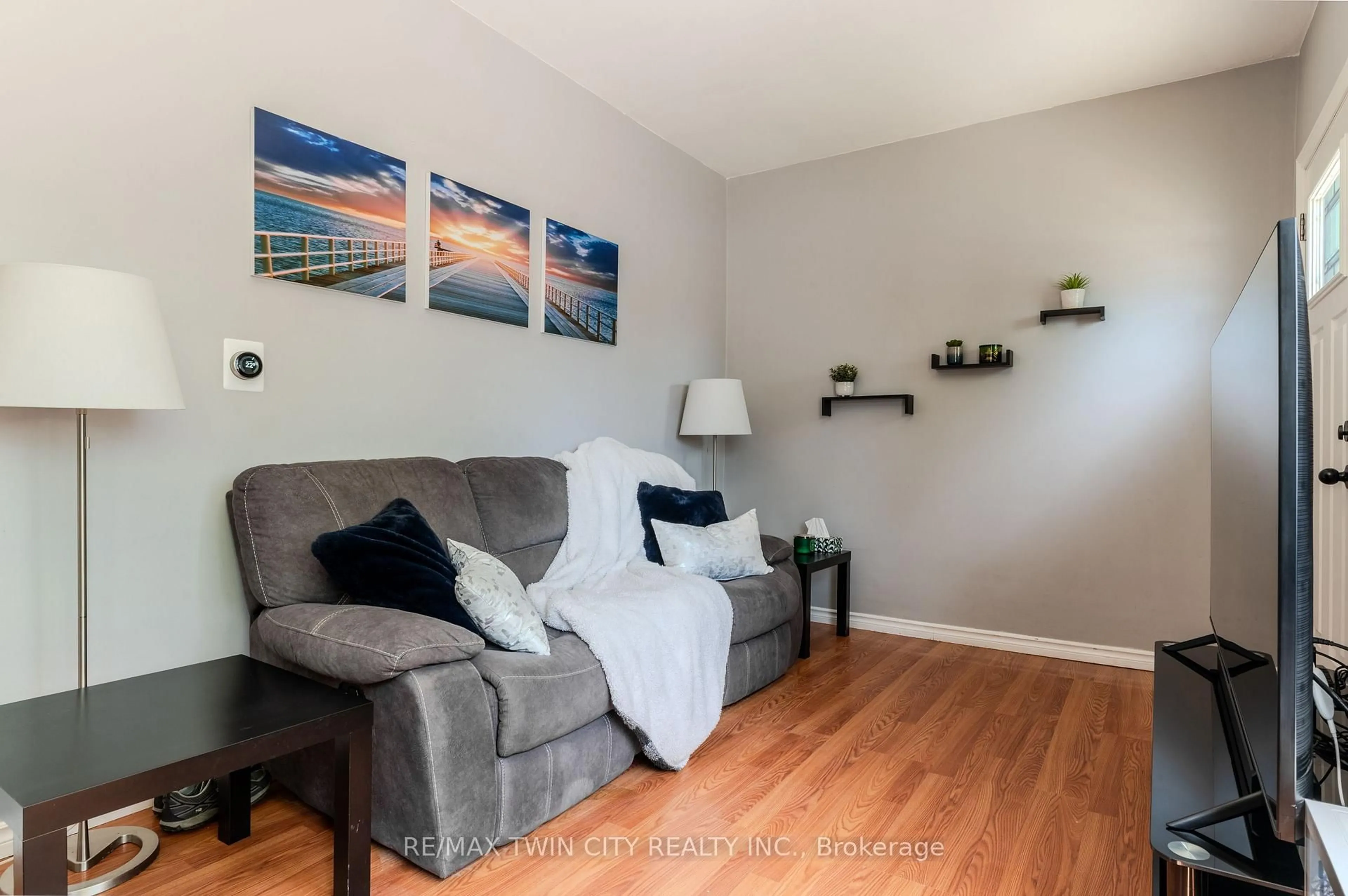 Living room with furniture, wood/laminate floor for 196 Grey St, Brantford Ontario N3S 4W5