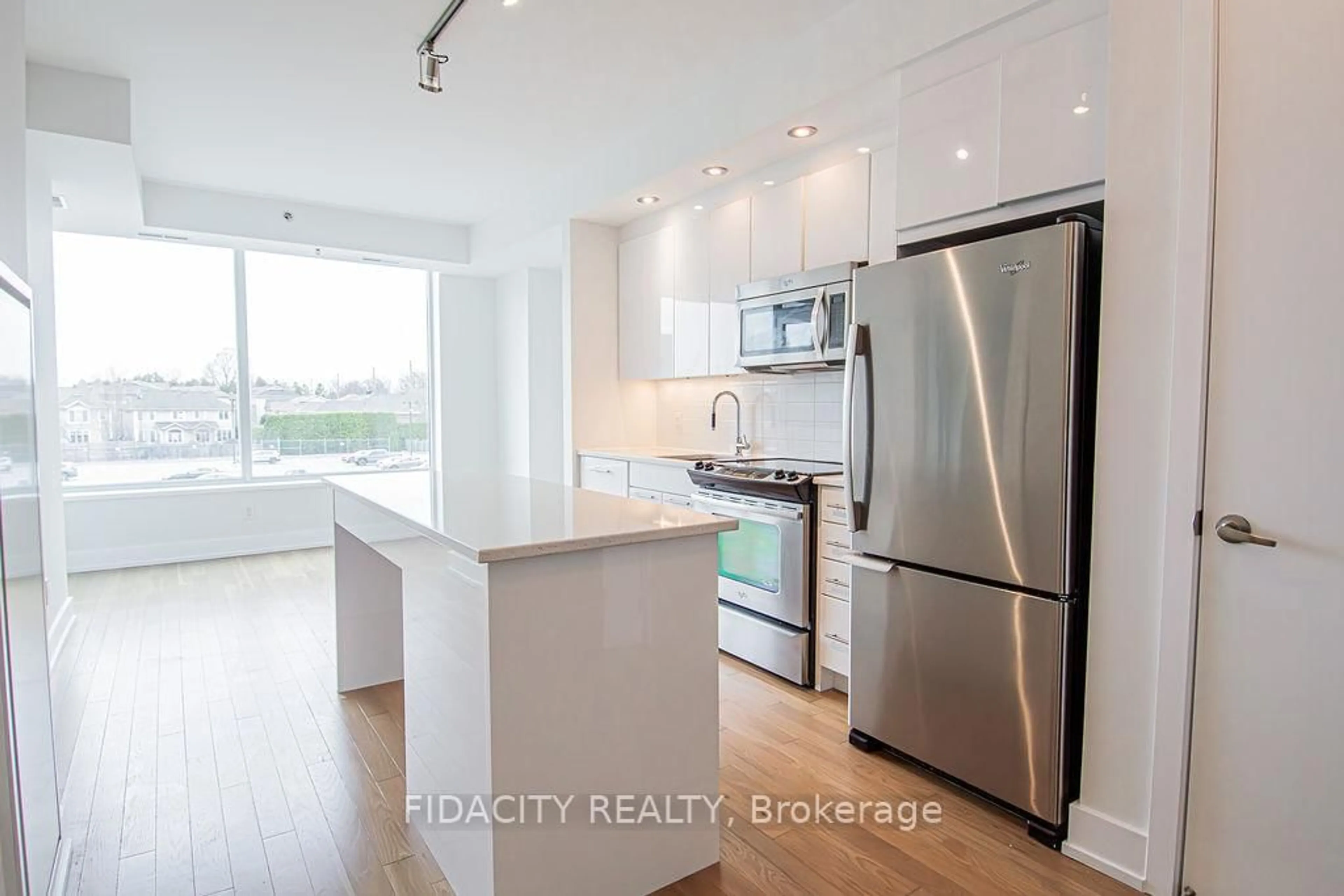 Open concept kitchen, wood/laminate floor for 360 Patricia Ave #206, Ottawa Ontario K1Z 0A8