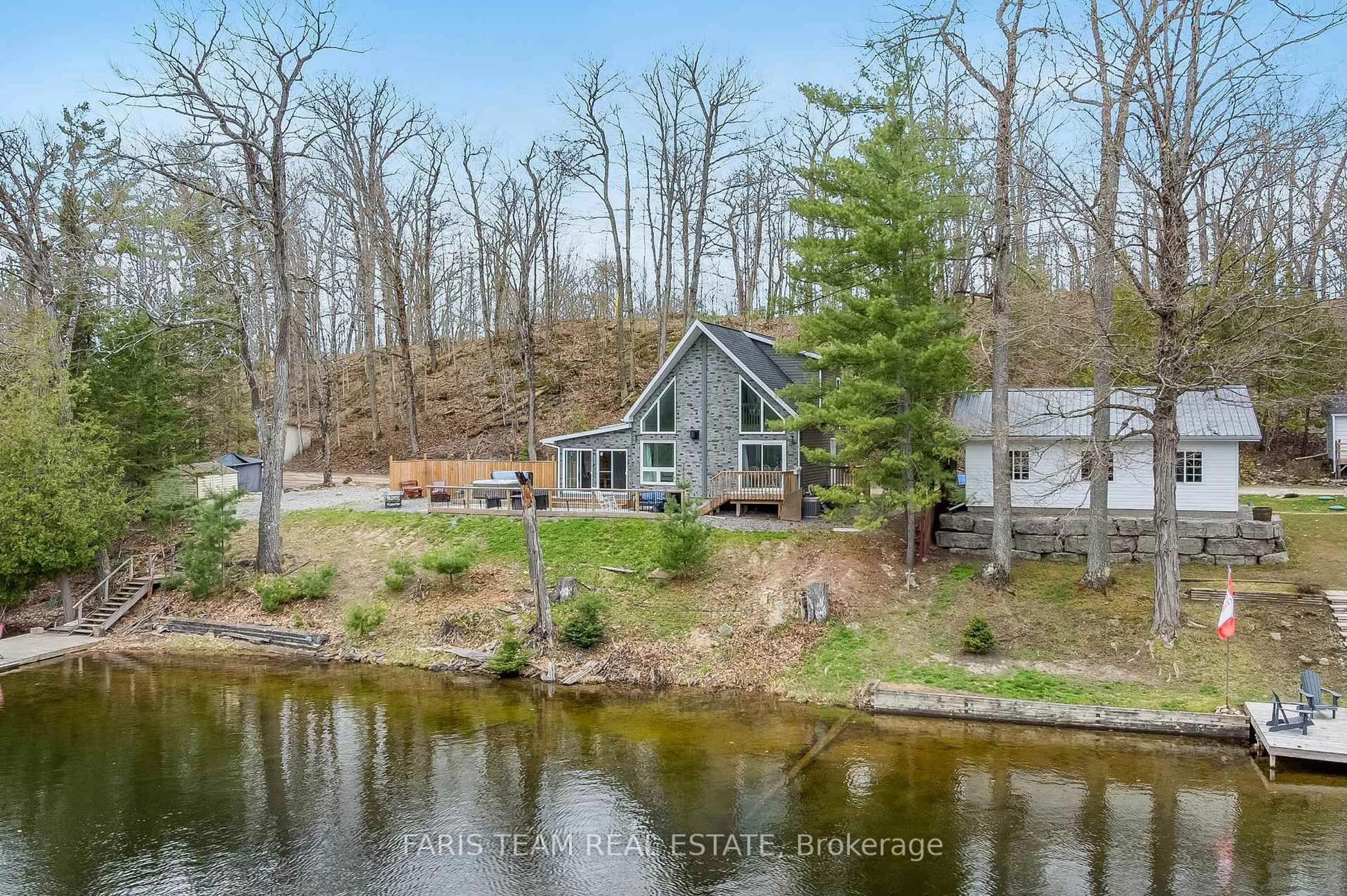 A pic from outside/outdoor area/front of a property/back of a property/a pic from drone, water/lake/river/ocean view for 1036 Beverley Lane, Minden Hills Ontario K0M 2L1
