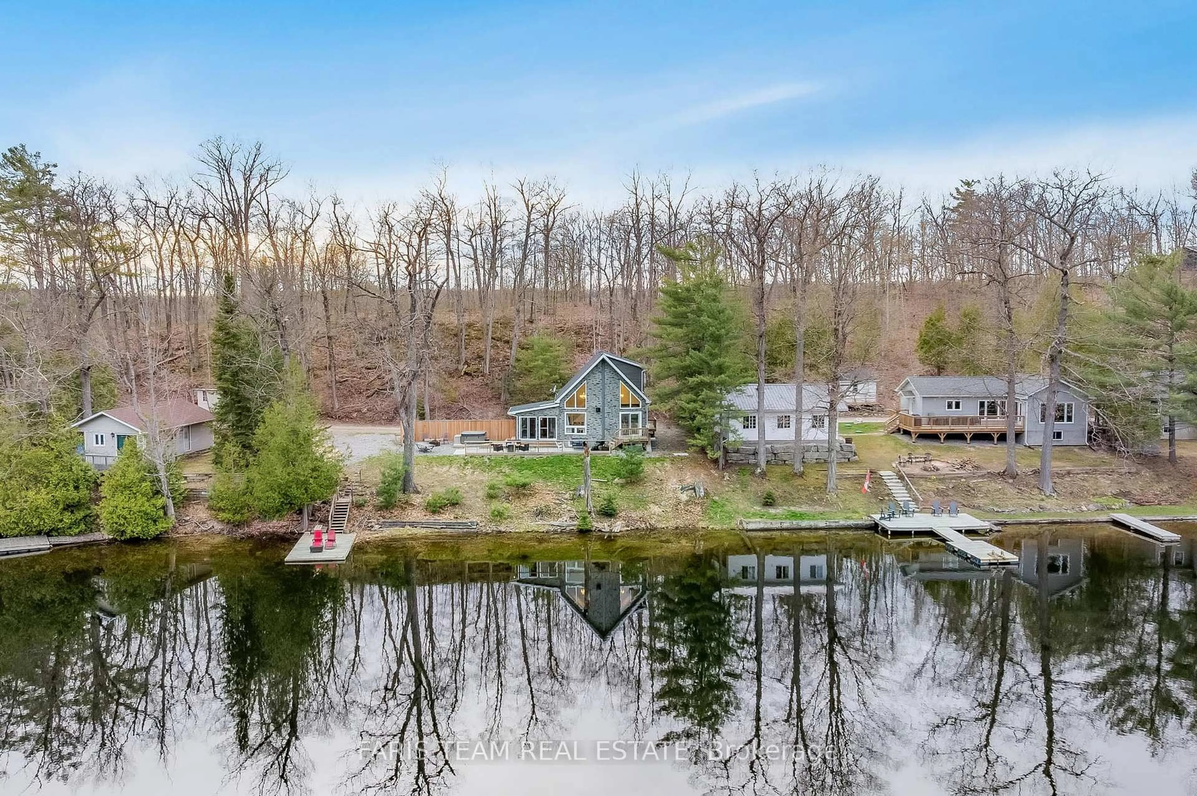 A pic from outside/outdoor area/front of a property/back of a property/a pic from drone, water/lake/river/ocean view for 1036 Beverley Lane, Minden Hills Ontario K0M 2L1