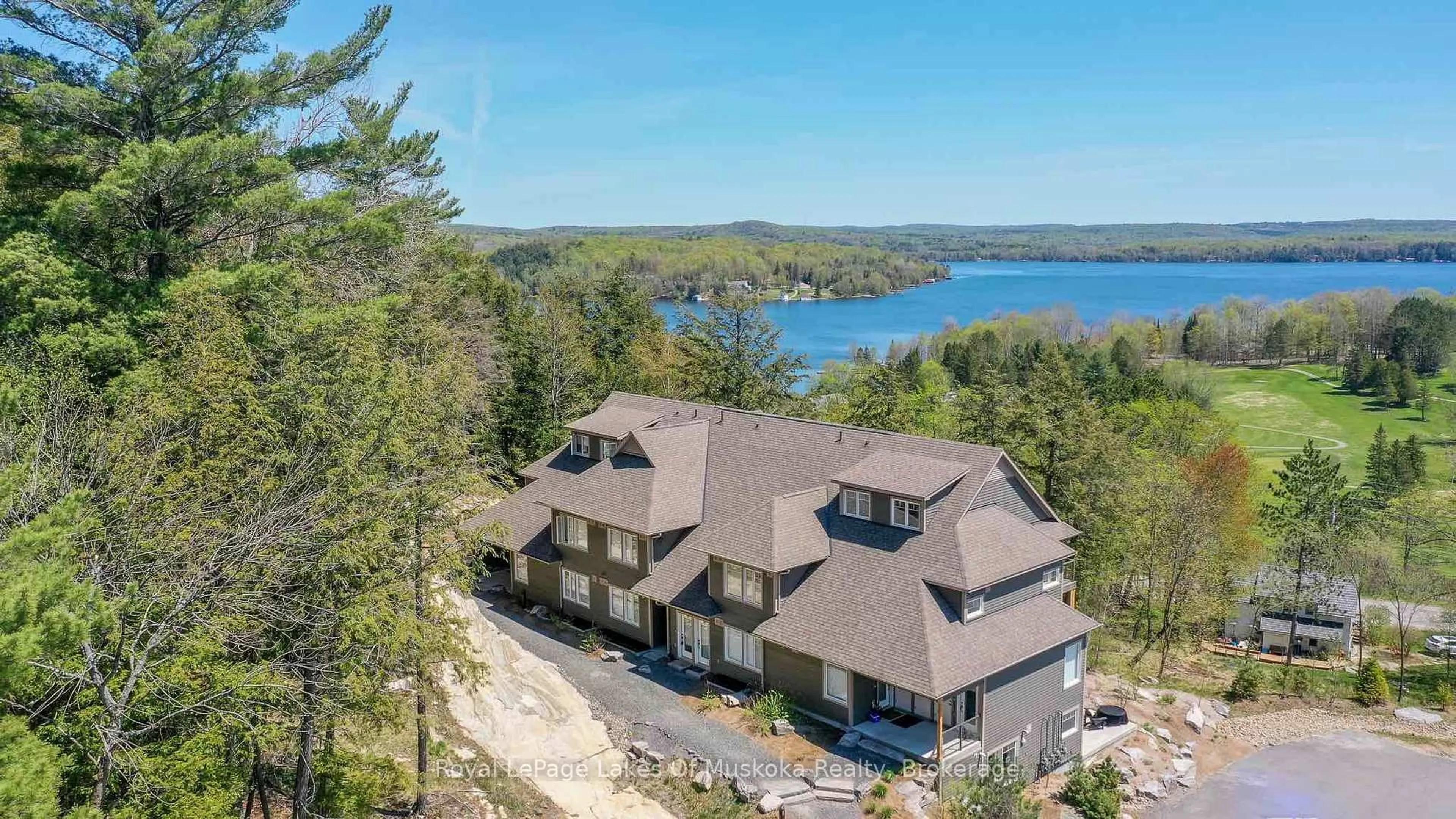 A pic from outside/outdoor area/front of a property/back of a property/a pic from drone, water/lake/river/ocean view for 3 TREE TOPS Lane #102, Huntsville Ontario P1H 0B8