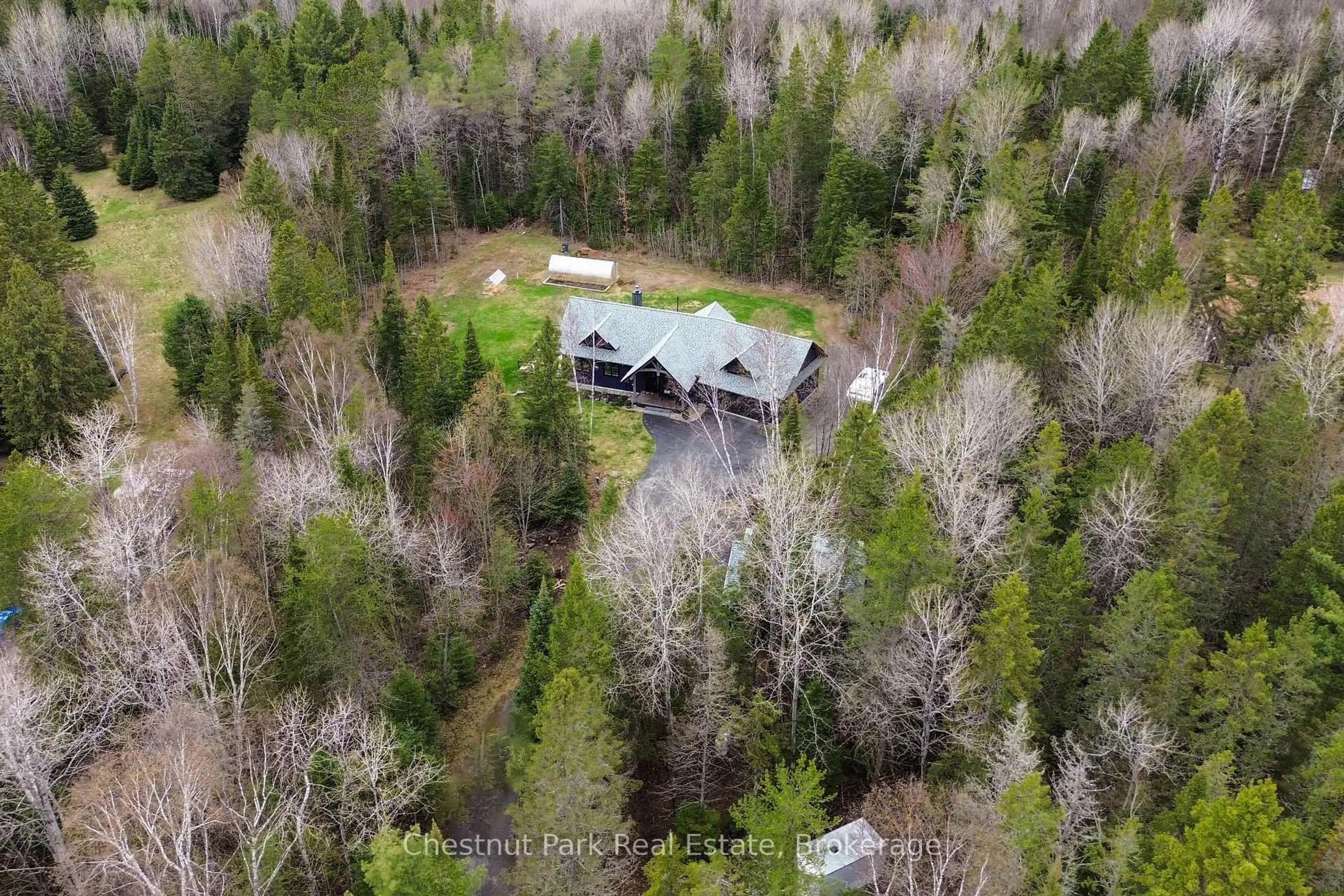 A pic from outside/outdoor area/front of a property/back of a property/a pic from drone, forest/trees view for 86 BOWYER Rd, Huntsville Ontario P1H 2J4