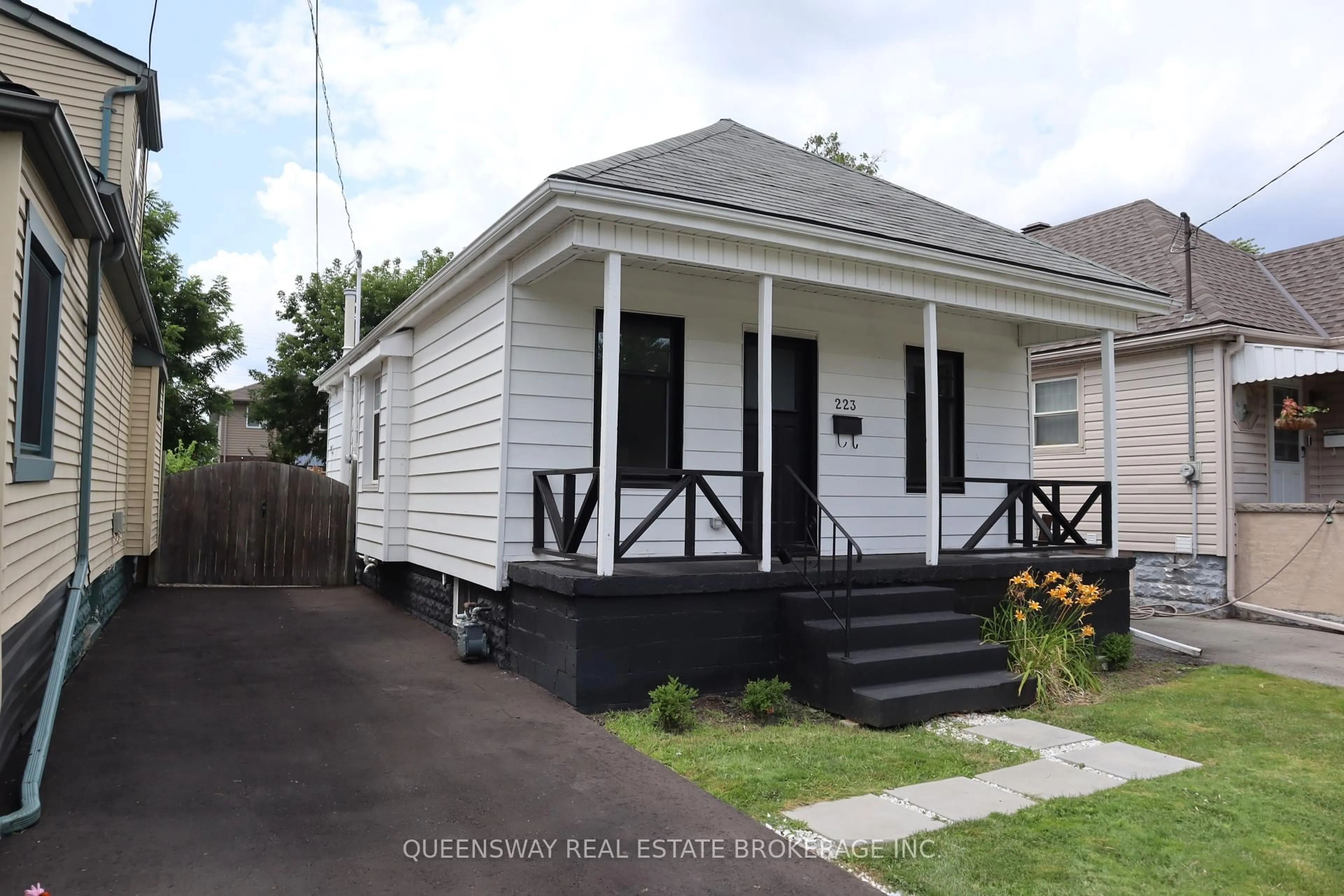 Home with vinyl exterior material, street for 223 Tolton Ave, Hamilton Ontario L8H 5P2